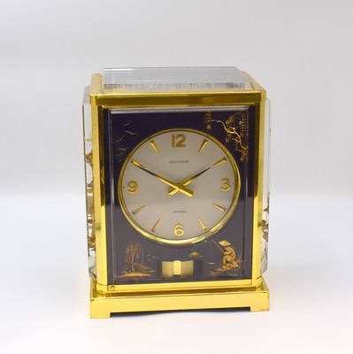 Image 26787944 - Jaeger-LeCoultre table clock series Atmos Marina, Switzerland around 1980, lavish case, Messingaußenteile gold plated, front and both sides with representation Chinese scene, gold-plated movement with torsion-pendulum, wound by barometric pressure changes, chain and barrel, Aneroid-cell, (Perpetuum-Mobile), measures approx. 23 x 18 x 14 cm, condition 2 -3
