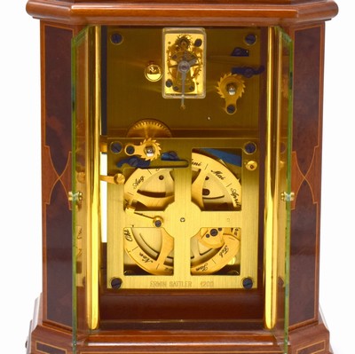 26787973d - ERWIN SATTLER rare, to 200 pieces limited table clock with perpetual calendar model 1294, Germany around 2000, key winding, specification from the year 1903, precious wood housing with gold-plated brass columns, bevelled glass, silvered dial with Arabic numerals, blue hands, gold-plated 8-days watch mechanism with 11 jewels calibre 1200, separate calendar work with 1 year duration of run, measures approx. 23 x 16,5 x 11,5 cm, original box, key, description and Certificate of origin enclosed, condition 2