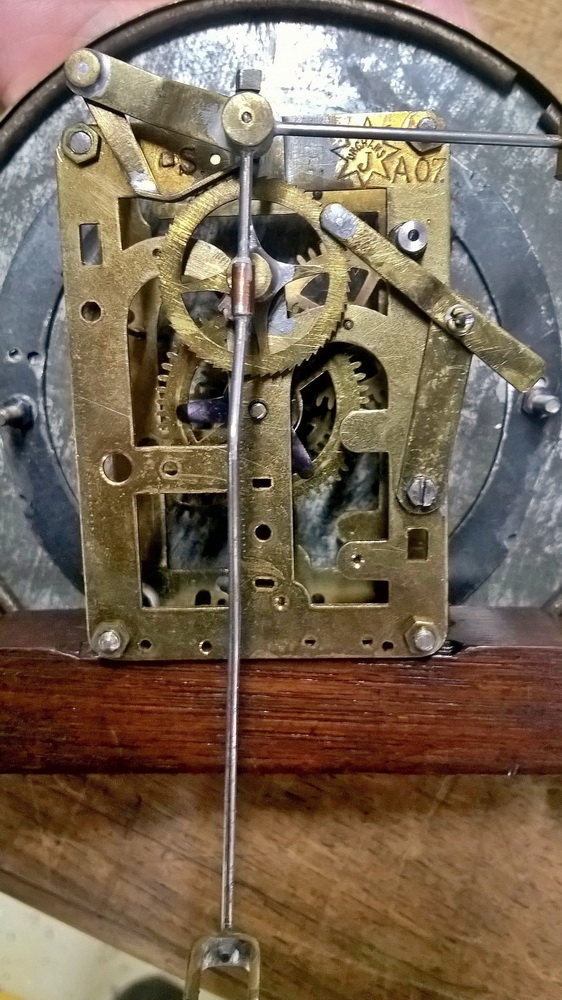 Detail e: Wanduhr, elektrisch, um 1930, Holzgehäuse verziert u. profiliert, sek. lackiert, Giebelabschluss, Türverschluss rechts mittels einzelner ...