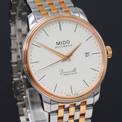 26788285c - MIDO Baroncelli Heritage nearly mint gents wristwatch reference M027407A, self winding, partial PVD-coated stainless steel case including original bracelet with butterfly buckle, on both sides glazed, case back screwed-down 4-times, silvered structure-dial with dash indices, gilded hands, date at 3, diameter approx. 39 mm, length approx. 22 cm, condition 1-2