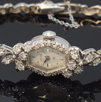 26790535a - HAMILTON 14k white gold and diamonds set ladies wristwatch, USA around 1965, manual winding, case with gold bracelet, safety chain, snap on case back, original winding crown, bezel as well as lugs lavish diamonds set, white dial with silvered hour-indices, silvered hands, calibre 761 with fausses cotes decoration, 22 jewels, diameter approx. 14 mm, total-weight approx. 18g, needs to be overhauled, condition 2