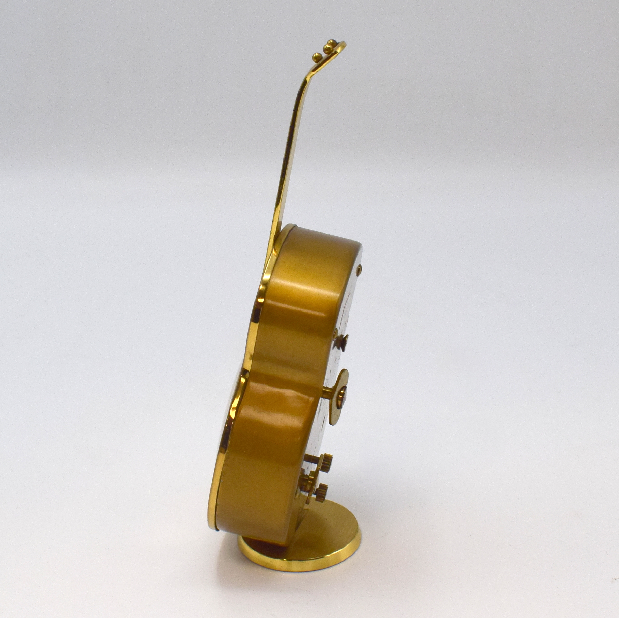 Detail d: SWIZA / PETER Konvolut von 2 Musik-Weckern, Schweiz / Deutschland um 1950, 1) SWIZA, lack. Messinggeh. in Gitarren-Form, silb. ovales Zifferbl., H. ...