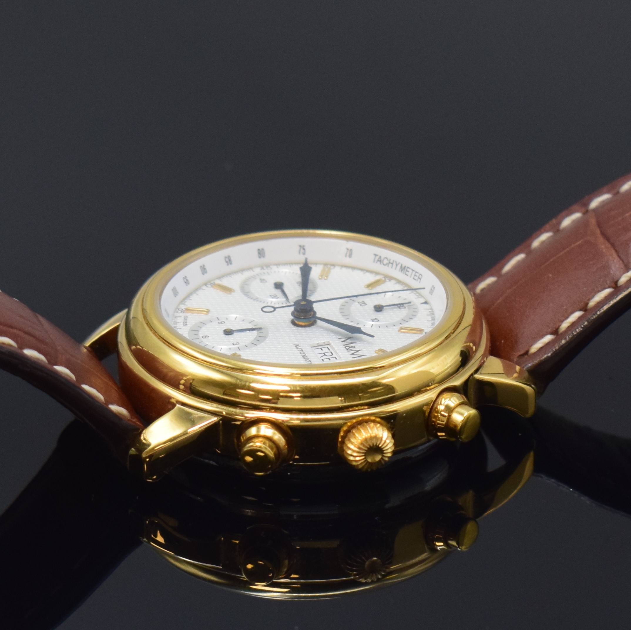 Detail b: M & M Armbandchronograph, Automatik, Schweiz um 1990, verg. Edelstahlgeh. beids. vergl., Boden und Glasrand aufgedr., silb., guill. Zifferbl. m. ...