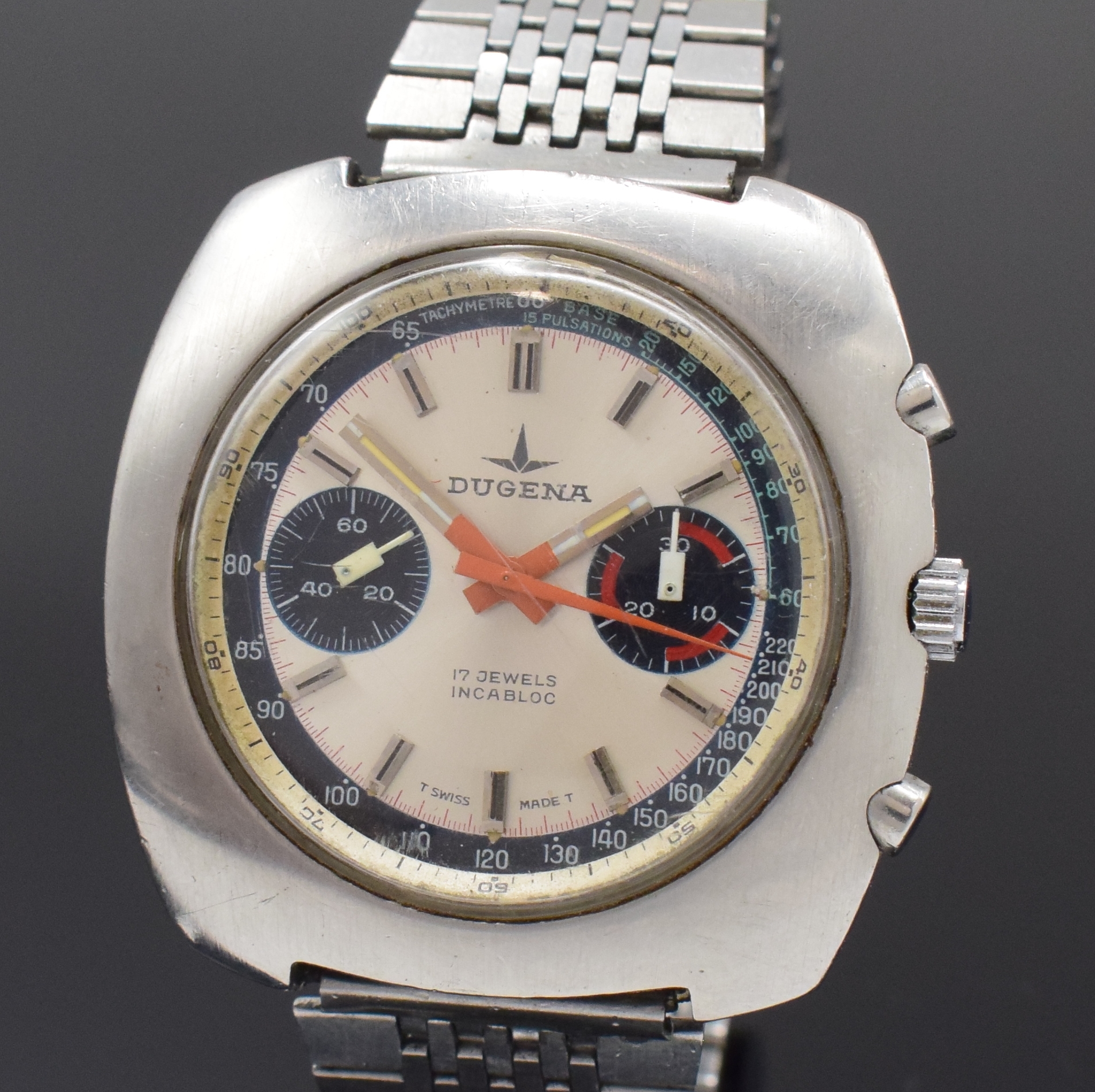 Detail a: DUGENA Armbandchronograph mit Kaliber Valjoux 7733 in Stahl, Schweiz um 1975, Handaufzug, Boden verschr., neutr. Band, silb. Zifferbl. m. aufges. ...