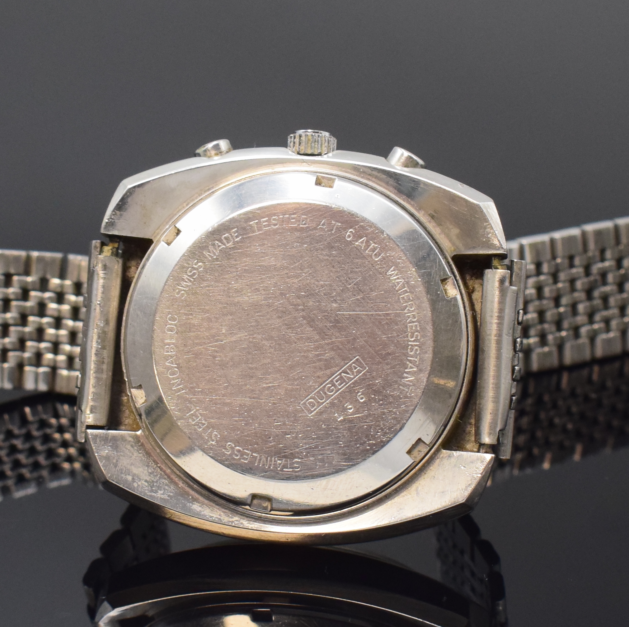 Detail c: DUGENA Armbandchronograph mit Kaliber Valjoux 7733 in Stahl, Schweiz um 1975, Handaufzug, Boden verschr., neutr. Band, silb. Zifferbl. m. aufges. ...