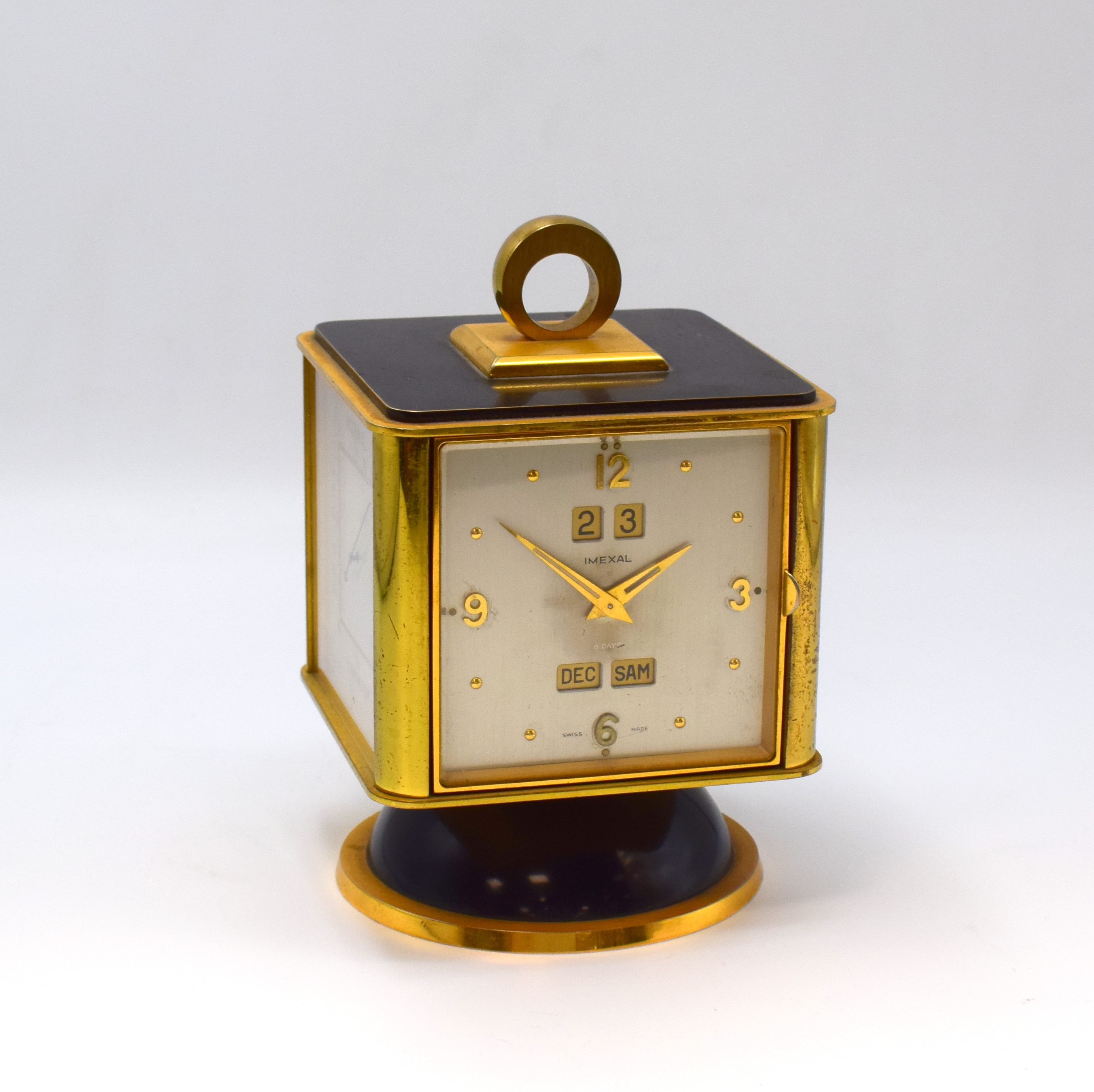 IMEXAL 4-Seitige Tischuhr mit Vollkalender, Hygrometer, Thermometer und Barometer, Schweiz um 1955, verg. Messinggeh., teilw. geschwärzt, drehbar ...
