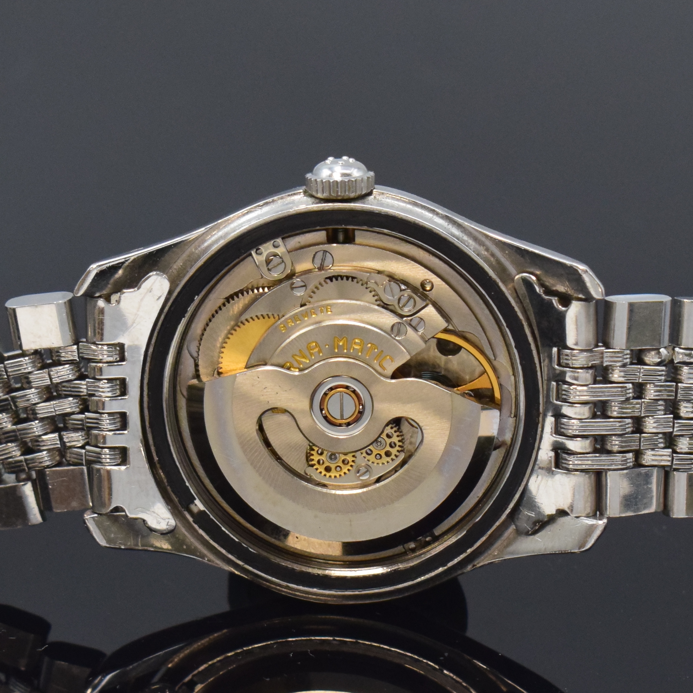 Detail e: ETERNA Kontiki Referenz 130T Herrenarmbanduhr in Stahl/Stahlband, Schweiz um 1960, Automatik, verschr. Geh., Boden m. Kontiki Gold-Plakette, orig. ...