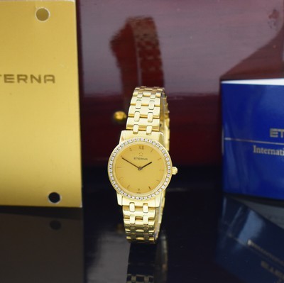 Image 26797163 - ETERNA 18k yellow gold ladies wristwatch with diamonds set bezel reference 3600.71, quartz, snap on case back and diamond bezel, bracelet with butterfly buckle, gilded dial, display of hours and minutes, calibre ETA 976.001, diameter approx. 25 mm, length approx. 17,5 cm, original papers, invoice copy and box without inlay, sold in August 1993, condition 2-3, weight approx. 72g
