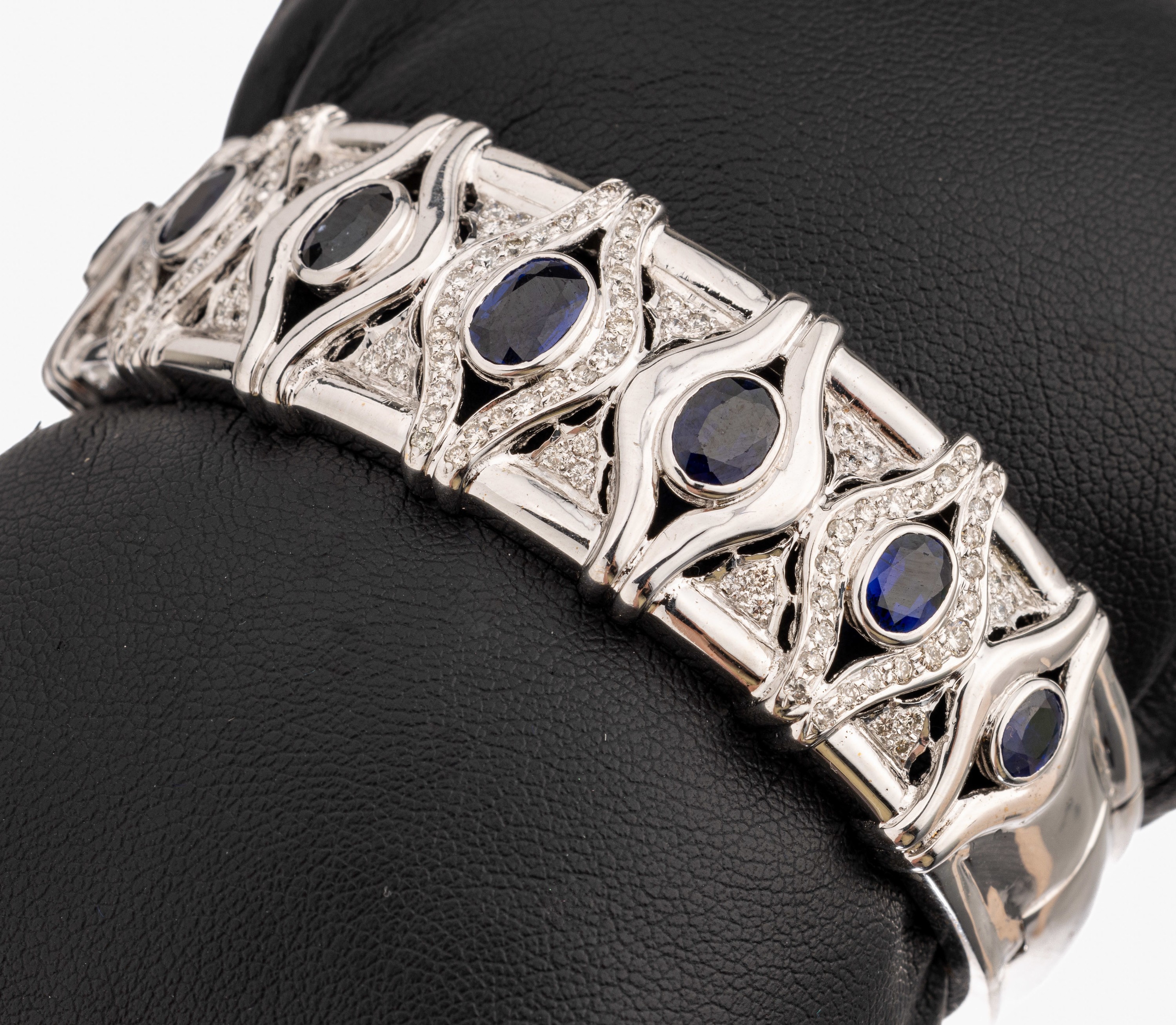 18 kt Gold Saphir-Brillant-Armreif, WG 750/000, 7 ovalfacett. Saphire zus. ca. 4.80 ct, Brillanten zus. ca. 0.90 ct Weiß/vs-si, Kastenschloss mit ...