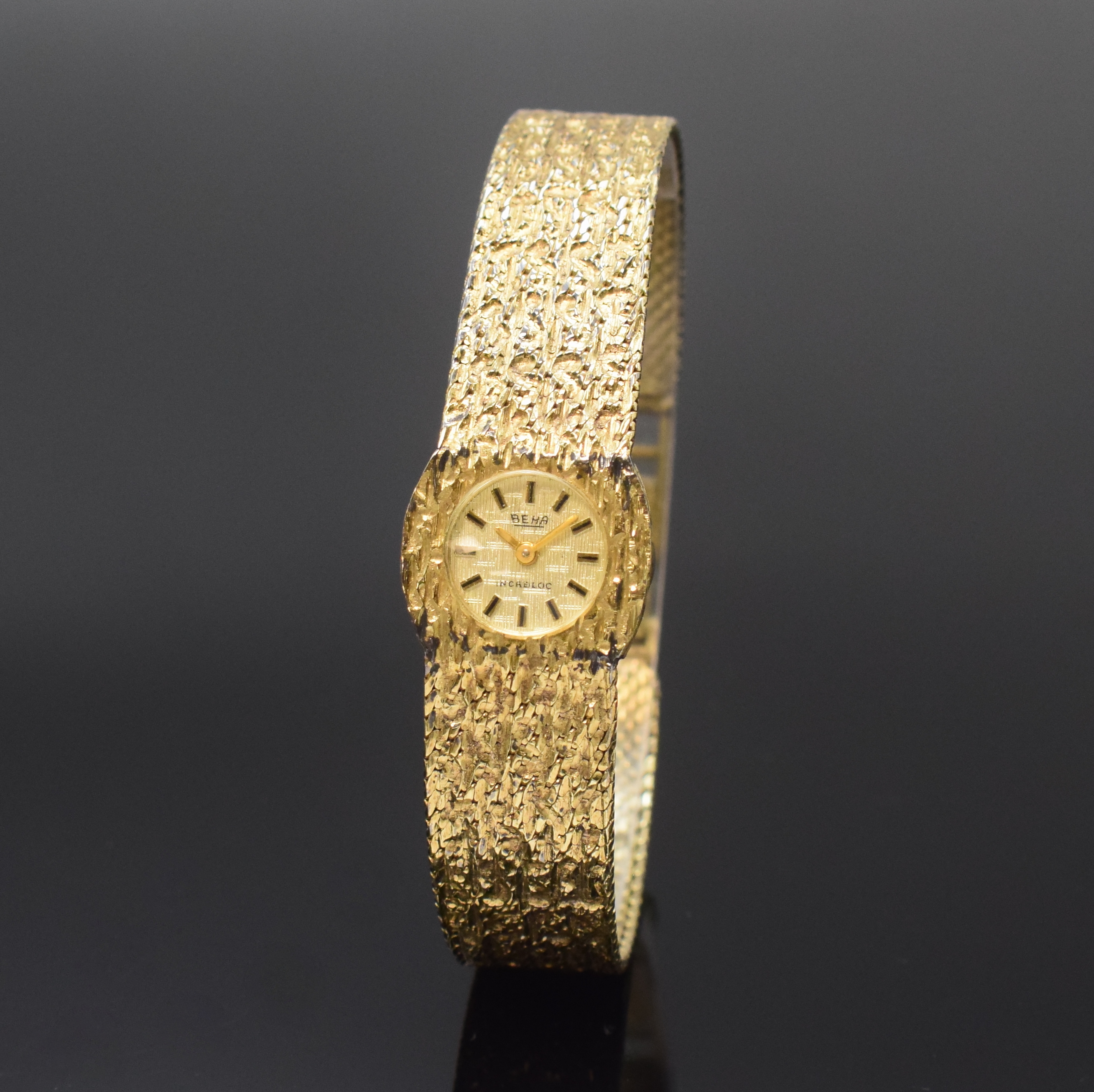 BEHA Damengoldbanduhr in GG 585/000, Schweiz um 1970, Handaufzug, Boden aufgedr., vers. strukt. Zifferbl. m. aufgel. Std.-Ind., gold. Zeiger, ...