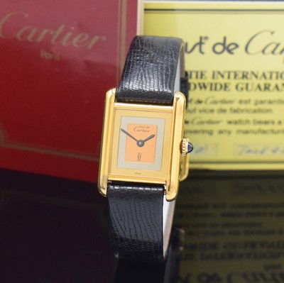 Image 26801431 - CARTIER Tank rectangular wristwatch, manual winding, gold-plated silver case, case at the sides 4-times screwed down, jeweled crown, tricolor-dial with blackened hands, measures approx. 28 x 21 mm, warranty card enclosed, signs of use, condition 2-3