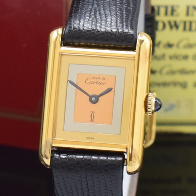 26801431a - CARTIER Tank rectangular wristwatch, manual winding, gold-plated silver case, case at the sides 4-times screwed down, jeweled crown, tricolor-dial with blackened hands, measures approx. 28 x 21 mm, warranty card enclosed, signs of use, condition 2-3