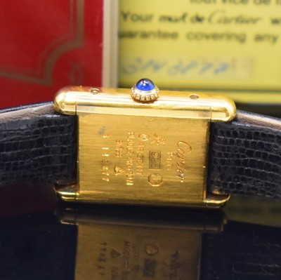 26801431b - CARTIER Tank rectangular wristwatch, manual winding, gold-plated silver case, case at the sides 4-times screwed down, jeweled crown, tricolor-dial with blackened hands, measures approx. 28 x 21 mm, warranty card enclosed, signs of use, condition 2-3