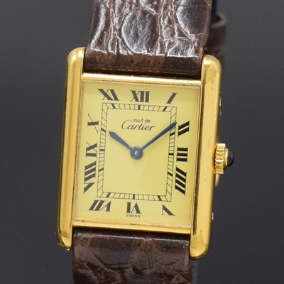 26801432a - CARTIER Tank ladies wristwatch, manual winding, gold-plated silver case, jeweled crown, case at the sides 4-times screwed down, champagne coloured dial with Roman numerals, blued steel hands, calibre 78-1 (base calibre ETA 2512-1) with fausses cotes decoration, 17 jewels, measures approx. 31 x 24 mm, condition 2-3