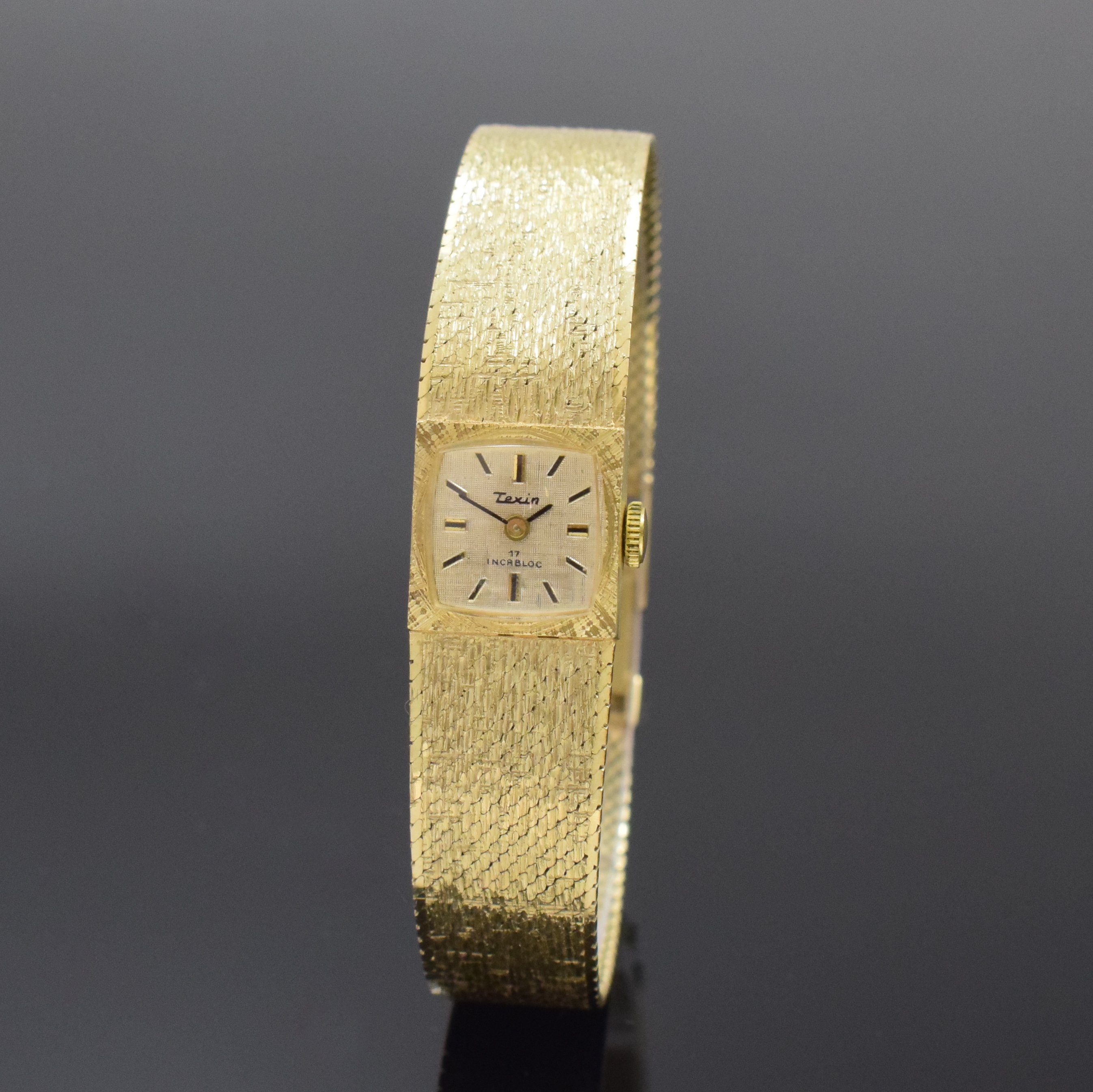 TEXIN Damenarmbanduhr in GG 585/000, Schweiz um 1970, Handaufzug, Geh. an Goldband, Boden aufgedr., vers. strukt. Zifferbl. m. aufges. Std.-Ind., ...