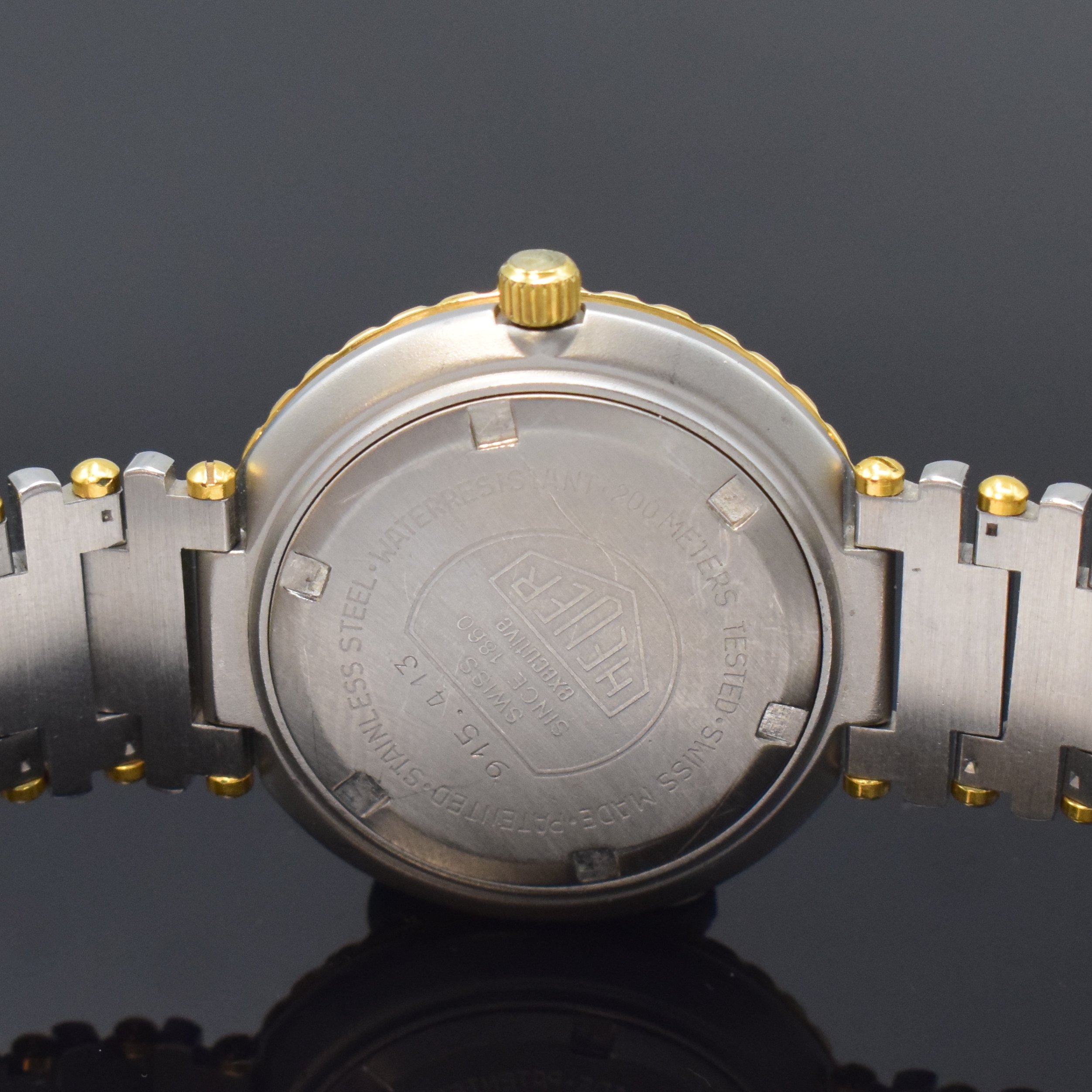 Detail d: HEUER professional Executive Armbanduhr Referenz 915.413, Schweiz um 1985, quarz, Edelstahlgeh. inkl. orig. Gliederband m. Faltschl., Boden u. Krone ...