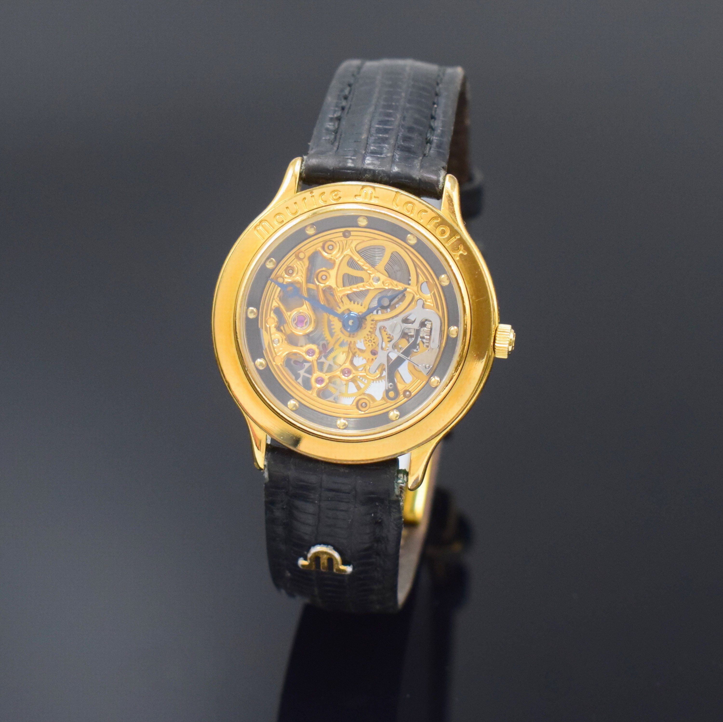 MAURICE LACROIX Skelettierte Armbanduhr, Schweiz um 1990, Handaufzug, verg. Geh. beids. vergl., Boden aufgedr., Lederband m. verg. dopp. Faltschl., ...