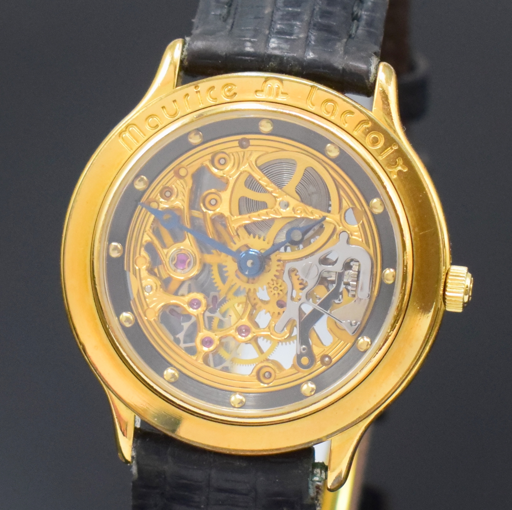 Detail a: MAURICE LACROIX Skelettierte Armbanduhr, Schweiz um 1990, Handaufzug, verg. Geh. beids. vergl., Boden aufgedr., Lederband m. verg. dopp. Faltschl., ...