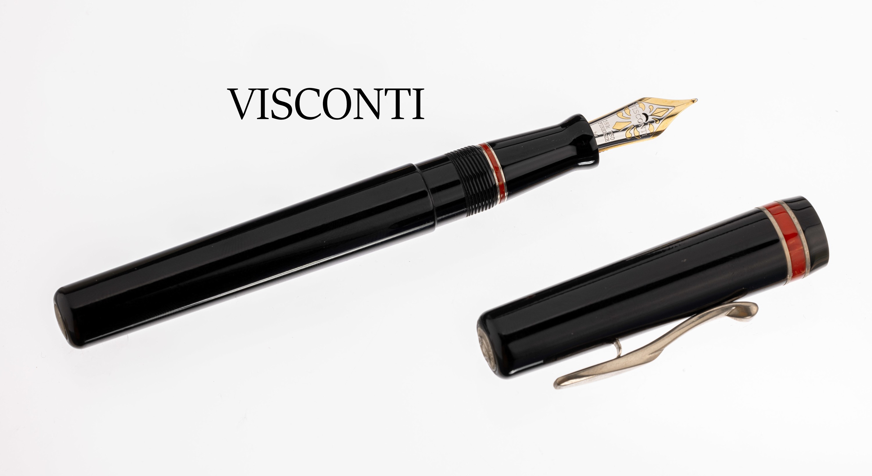 Visconti Füllfederhalter, schwarzes Celluloid mit rotem Zierring am Füller und an der Kappe, Feder 18 kt Gold, orig. Etui mit ...