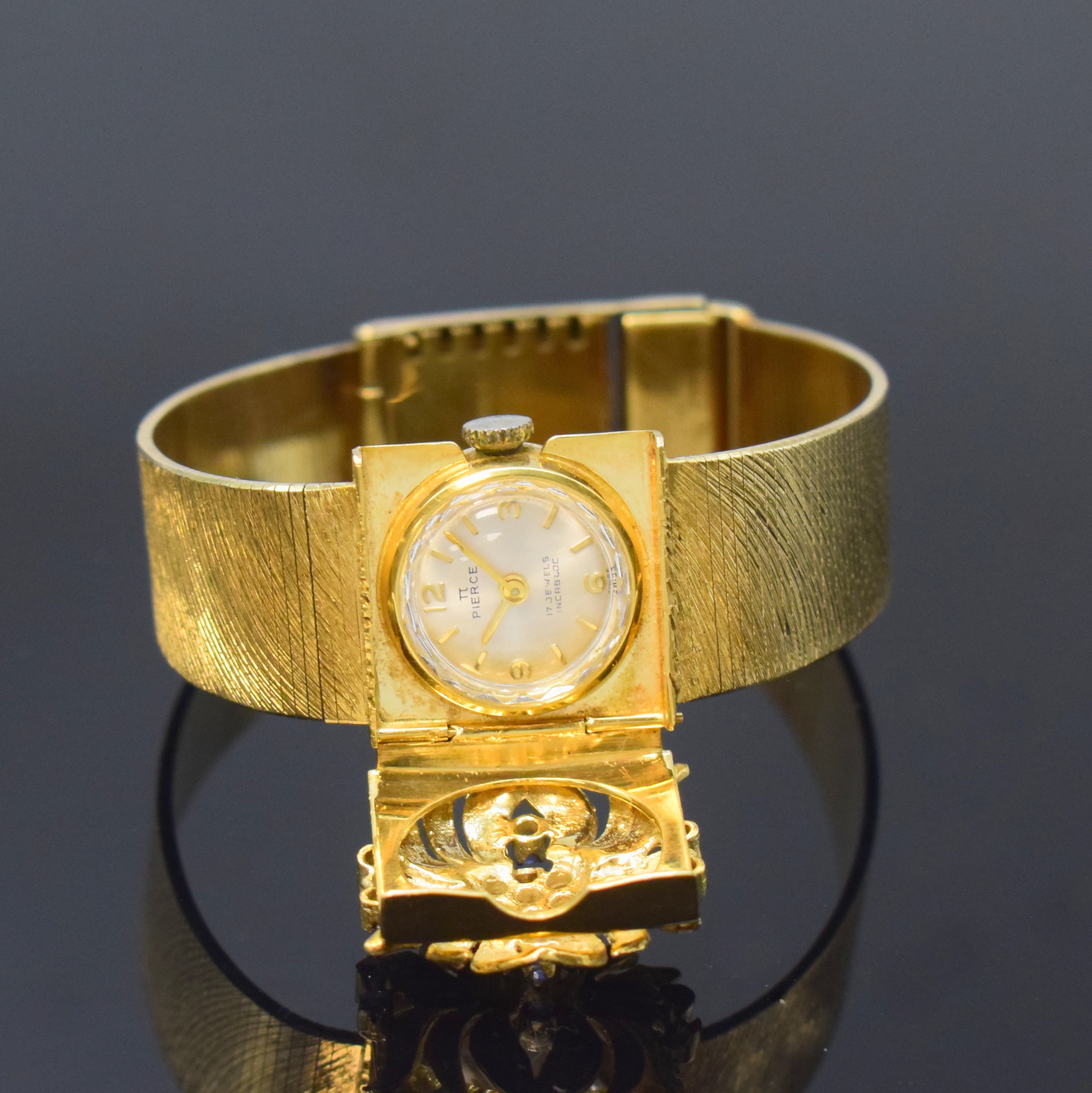 PIERCE Damenschmuckuhr in GG 585/000, Schweiz um 1960, Handaufzug, quadrat. Geh. m. anges. strukturiertem Goldband, floral verzierter u. durchbr. ...