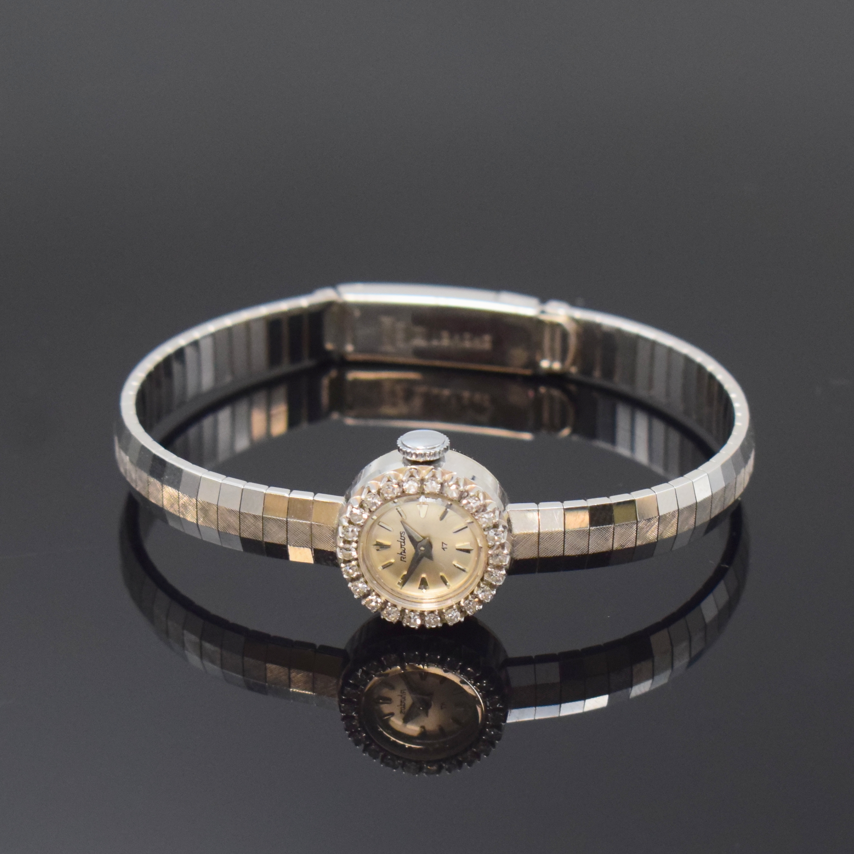 RHODOS Diamant-besetzte Damenarmbanduhr in WG 750/000, Schweiz um 1960, Handaufzug, 2-tlg. Geh., Boden aufgedr., anges., teils pol./teils satiniertes ...