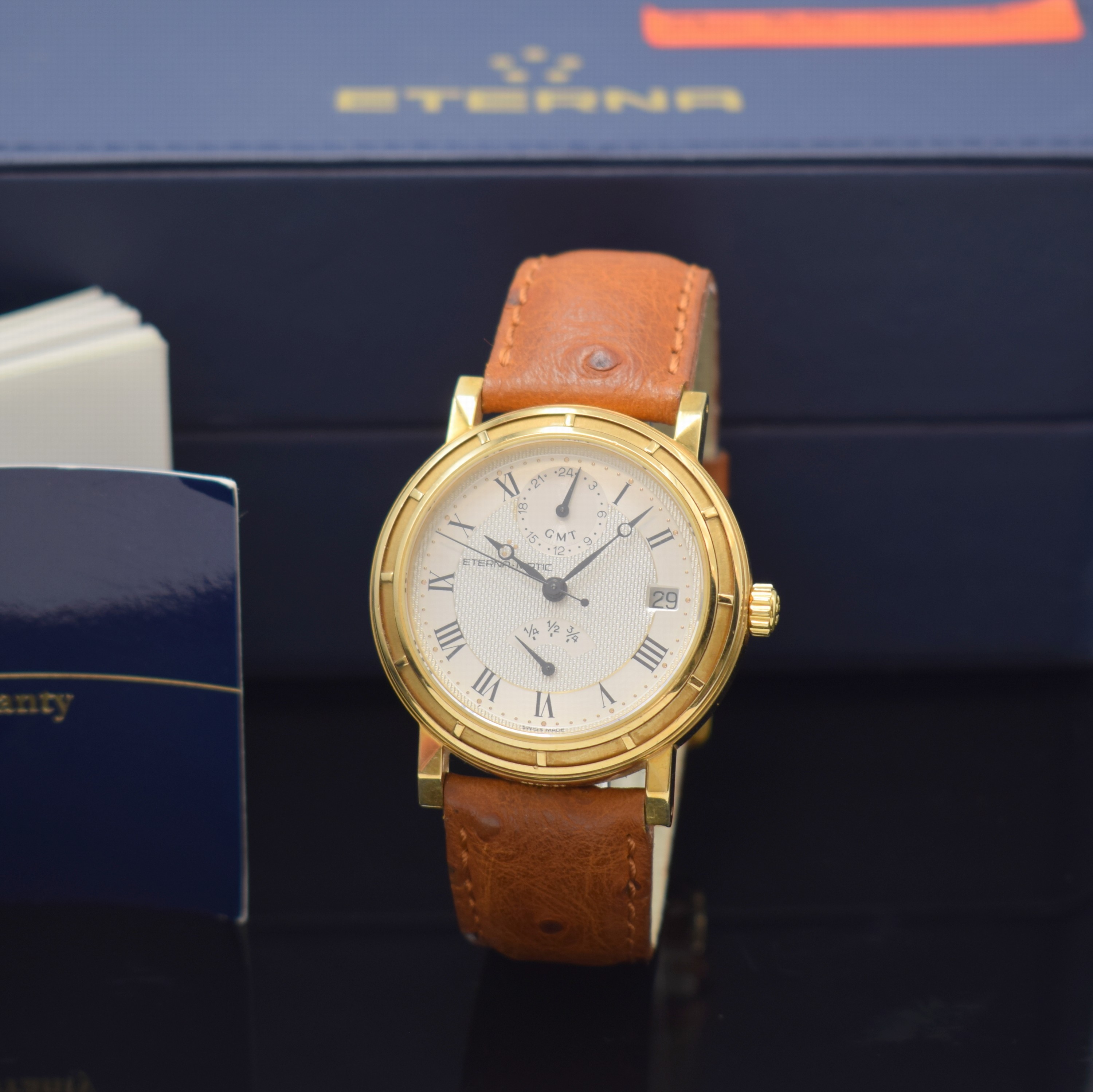 ETERNA MATIC Herrenarmbanduhr mit Gangreserveanzeige und GMT in GG 750/000, Automatik, Schweiz um 1995, massives Geh. beids. vergl., Lederband m. ...