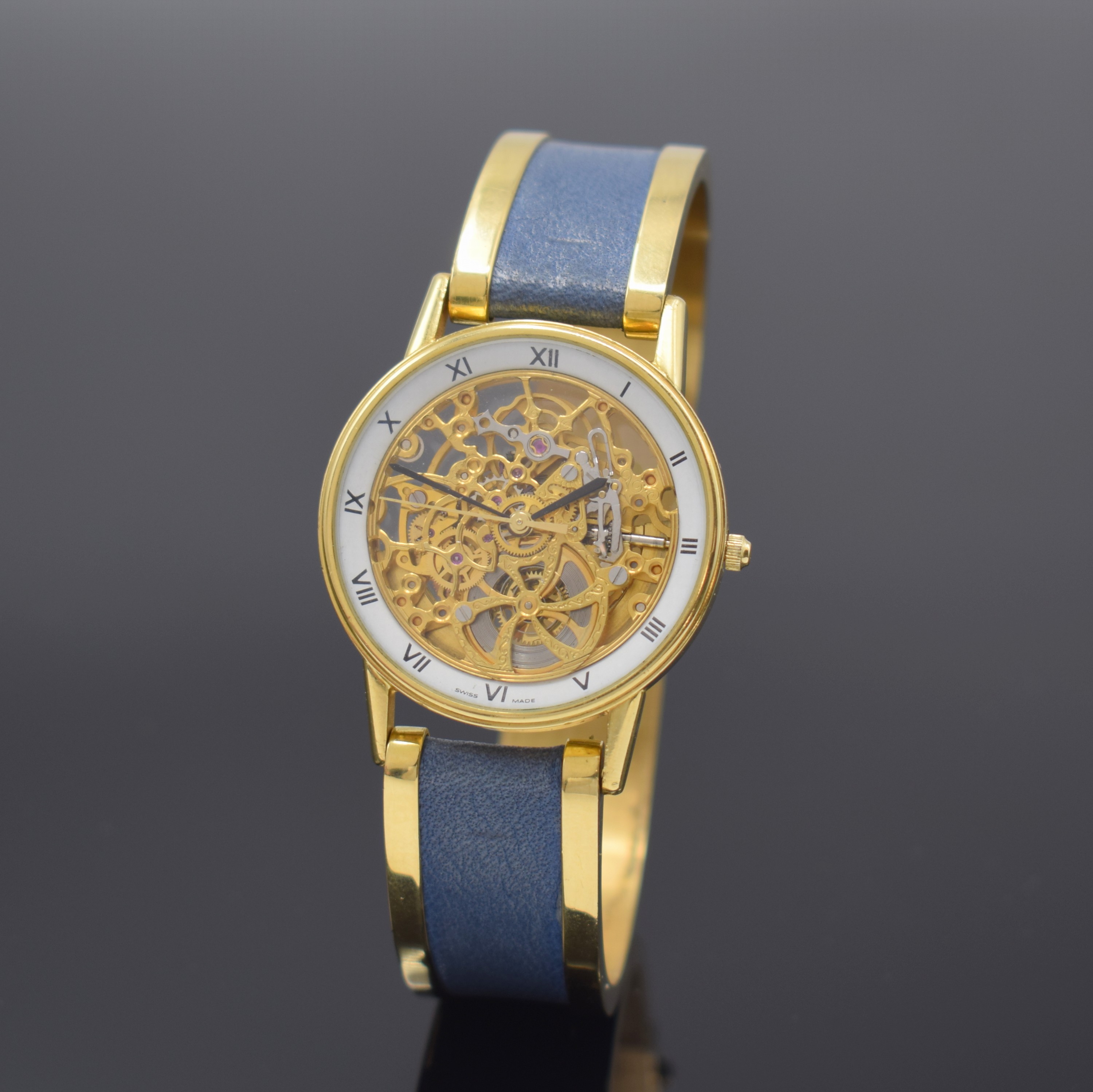 Feine, skelettierte Armbanduhr in GG 750/000 an GG 750/000 Armspange, Automatik, 1990er Jahre, beids. vergl., Boden aufgedr., weisser Ziffernring m. ...