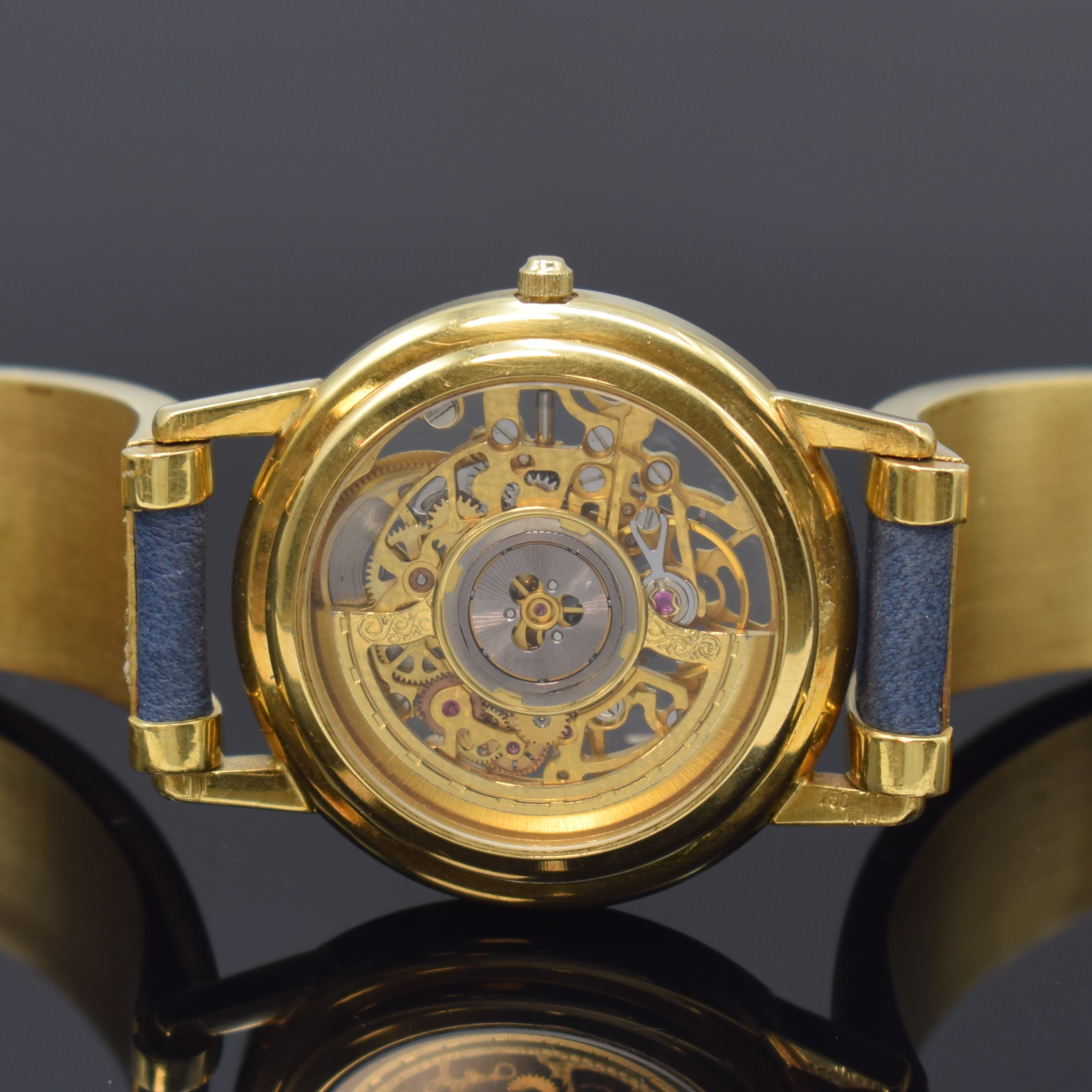 Detail c: Feine, skelettierte Armbanduhr in GG 750/000 an GG 750/000 Armspange, Automatik, 1990er Jahre, beids. vergl., Boden aufgedr., weisser Ziffernring m. ...