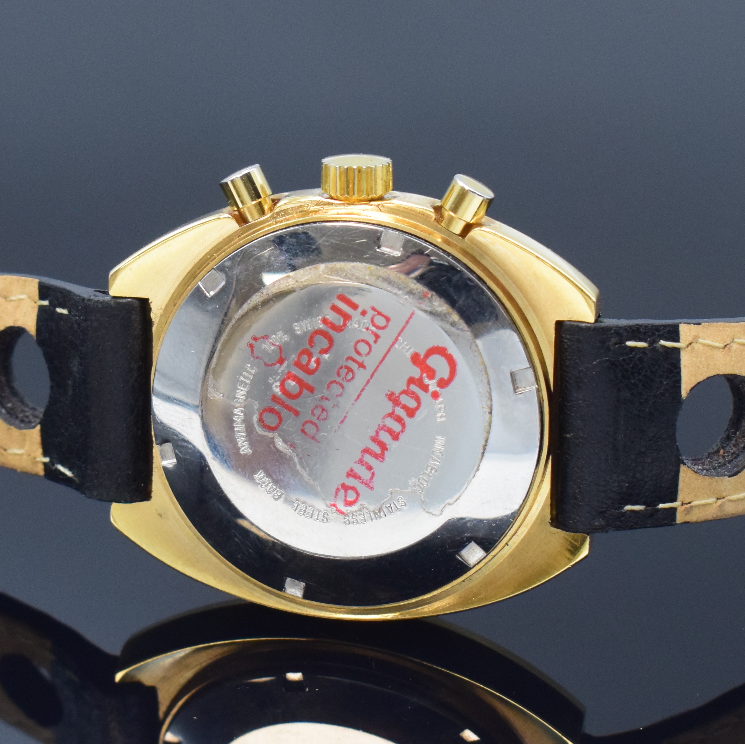 Detail c: WAKMANN / GIGANDET Herrenarmbanduhr mit Chronograph, Schweiz um 1970, Handaufzug, verg. Geh., Stahlboden verschr., gold. Zifferbl., schwarz. ...