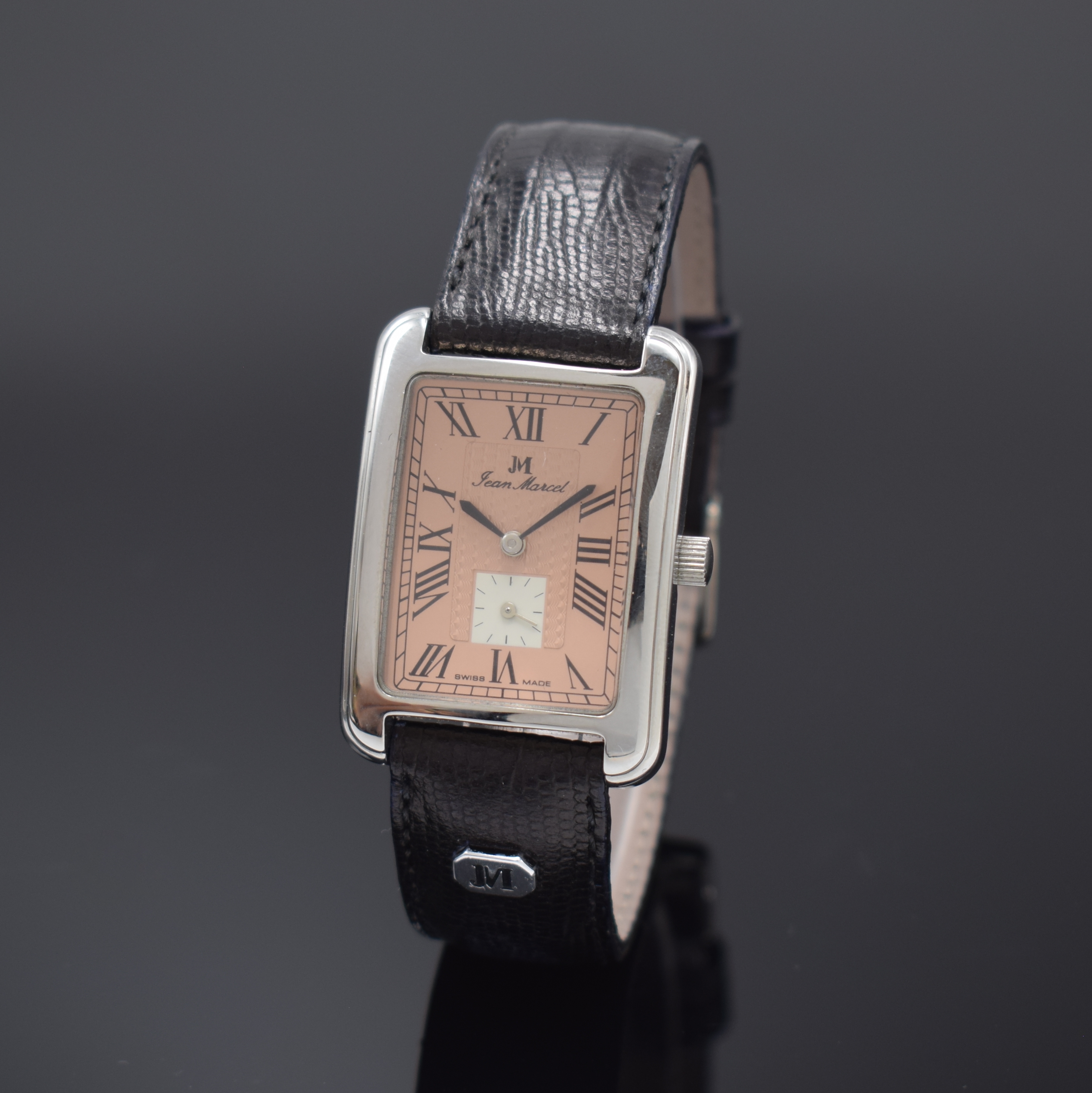 JEAN MARCEL rechteckige Armbanduhr in Stahl, Schweiz um 1990, Handaufzug, beids. vergl. Geh., Boden 4-fach verschr., lachsfarb. Zifferbl. m. ...