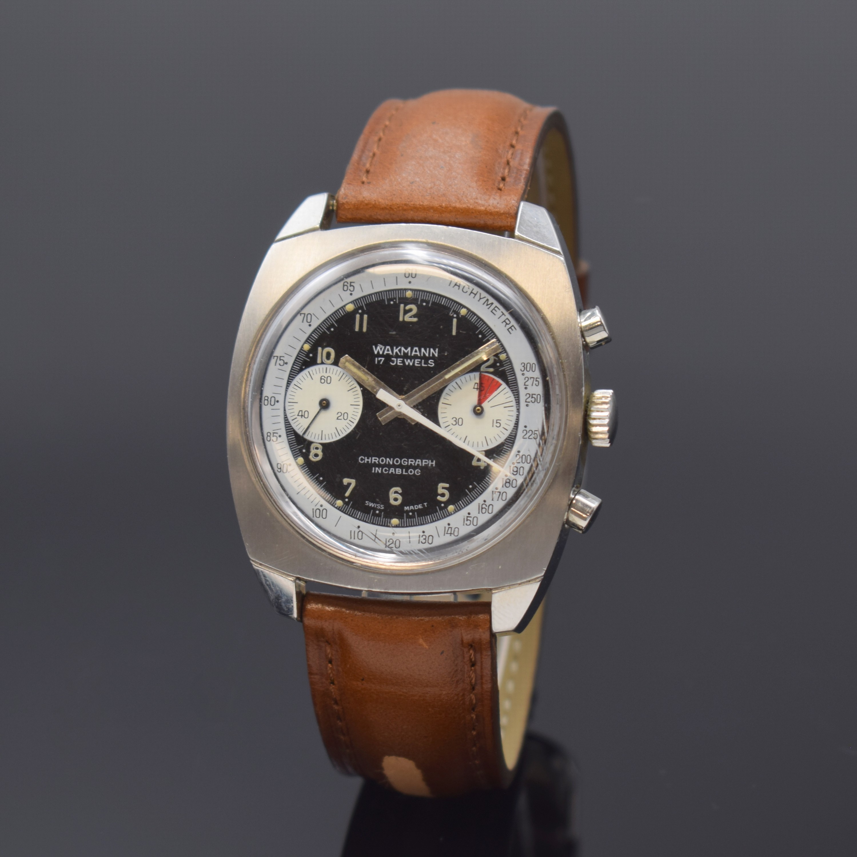 WAKMANN Armbandchronograph in Stahl, Schweiz um 1970, Handaufzug, Kissenförm. Geh., Boden verschr., schwarz. Zifferbl., weisse Hilfsblätter, arab. ...