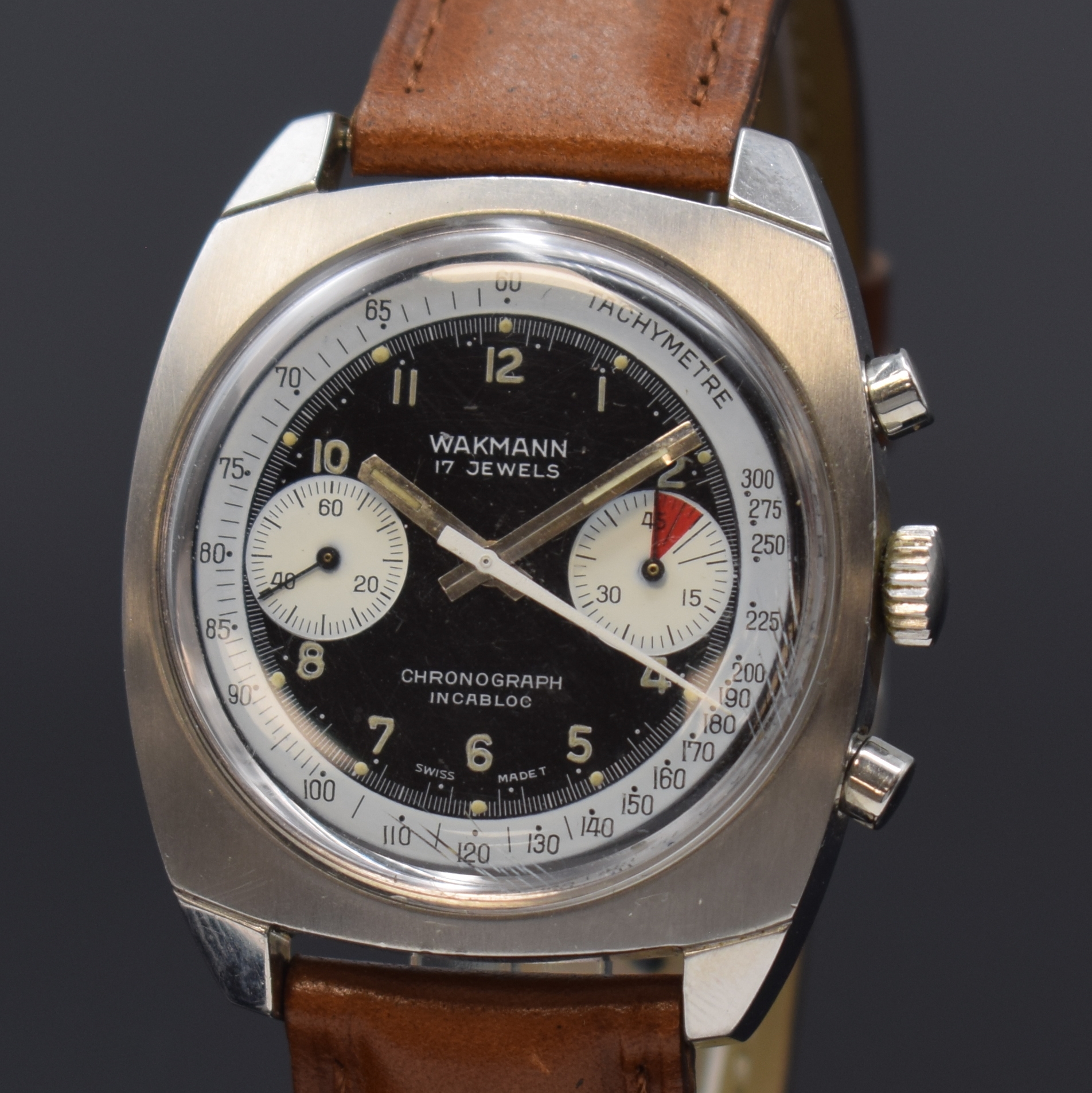 Detail a: WAKMANN Armbandchronograph in Stahl, Schweiz um 1970, Handaufzug, Kissenförm. Geh., Boden verschr., schwarz. Zifferbl., weisse Hilfsblätter, arab. ...