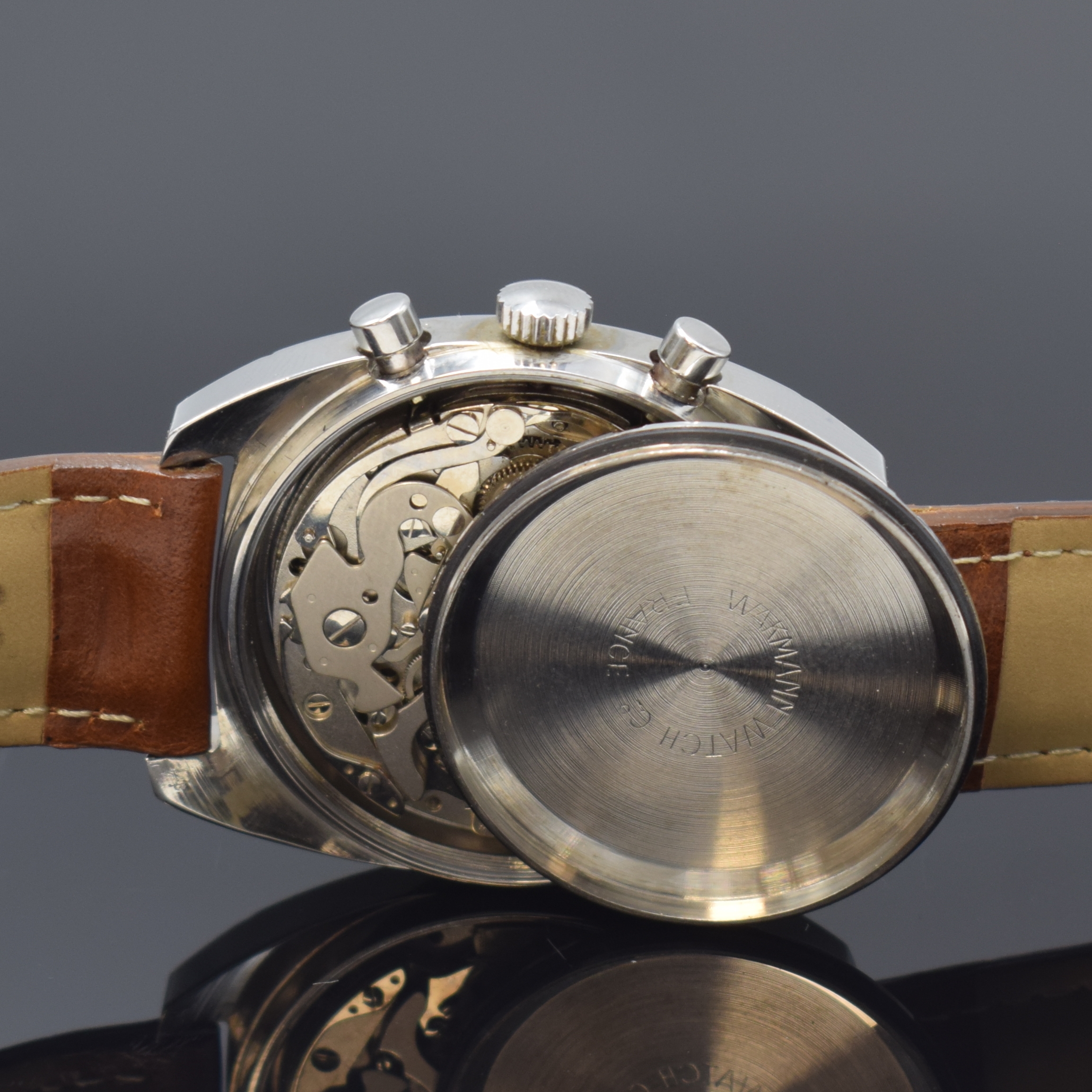 Detail e: WAKMANN Armbandchronograph in Stahl, Schweiz um 1970, Handaufzug, Kissenförm. Geh., Boden verschr., schwarz. Zifferbl., weisse Hilfsblätter, arab. ...