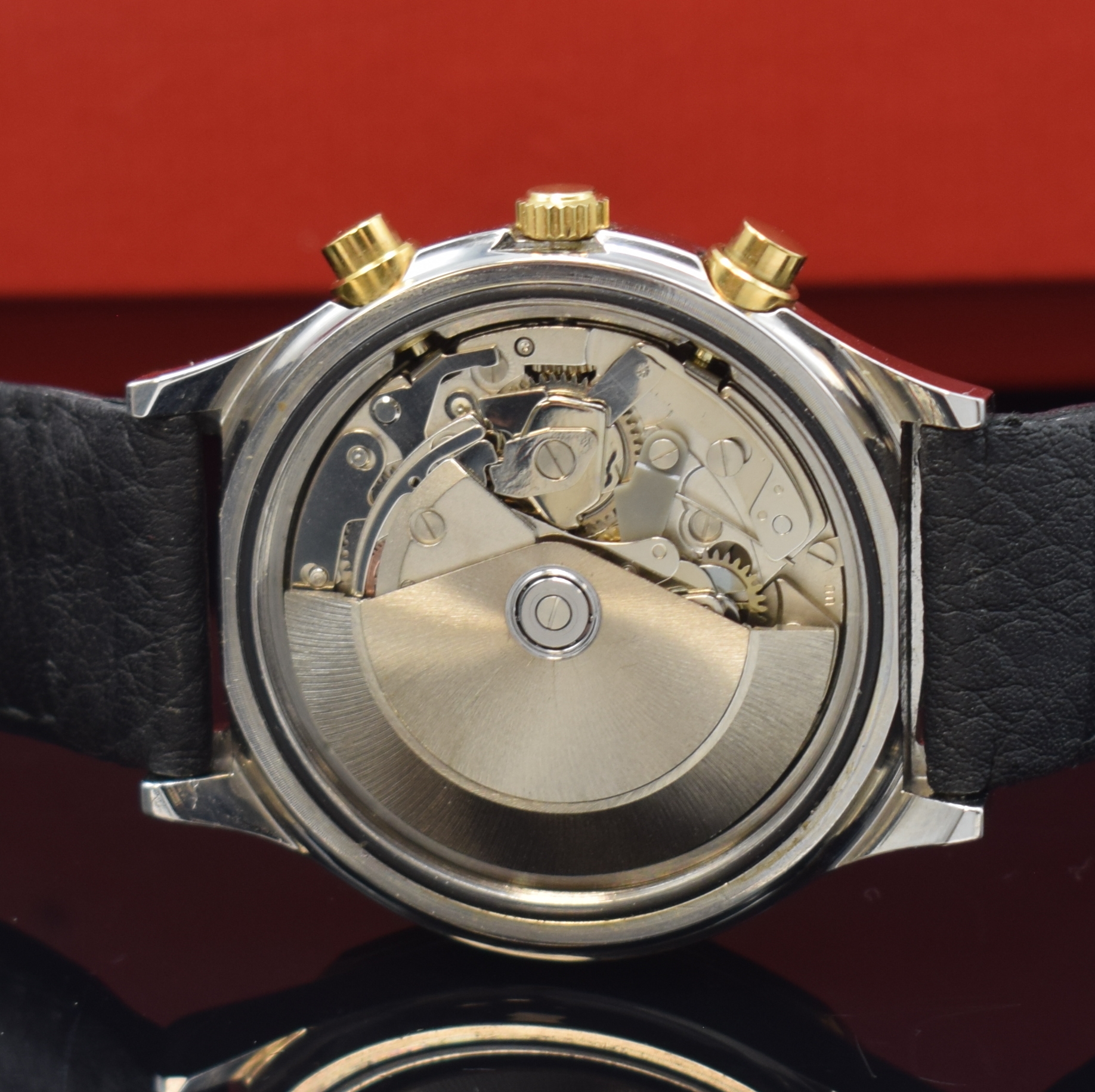 Detail e: TISSOT PRX Armbandchronograph, Schweiz um 1990, Automatik, Stahlgeh. m. verg. 12-eckiger Lünette, Boden verschr., schwarz. Waffel- Zifferbl., gold. ...