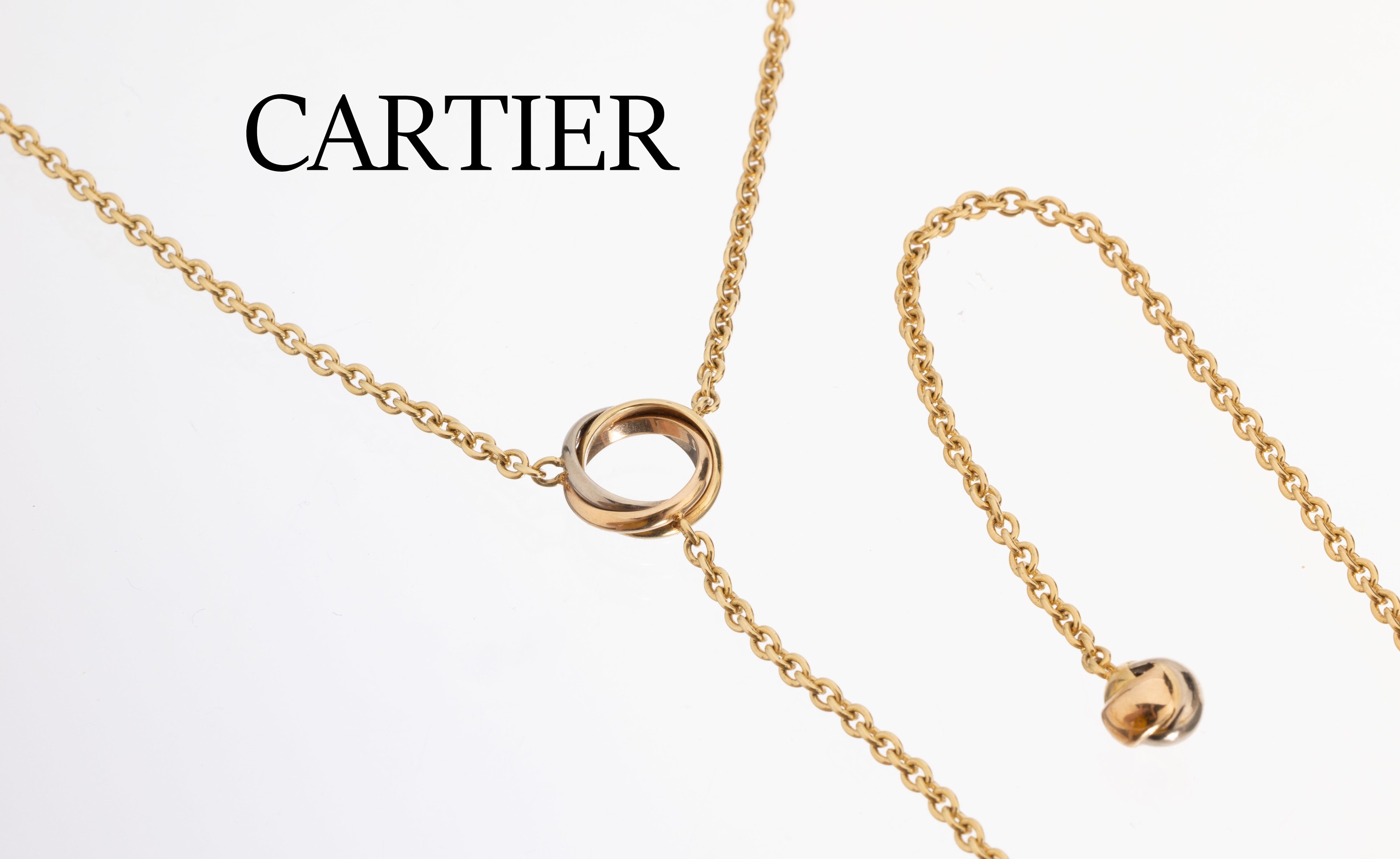 18 kt Gold CARTIER Y-Collier , GG/WG/RG 750/000, Mittelteil mit Trinity Ring, Ende mit einer Trinity Kugel, durch einfädeln in den Ring auch 4-rhg. ...