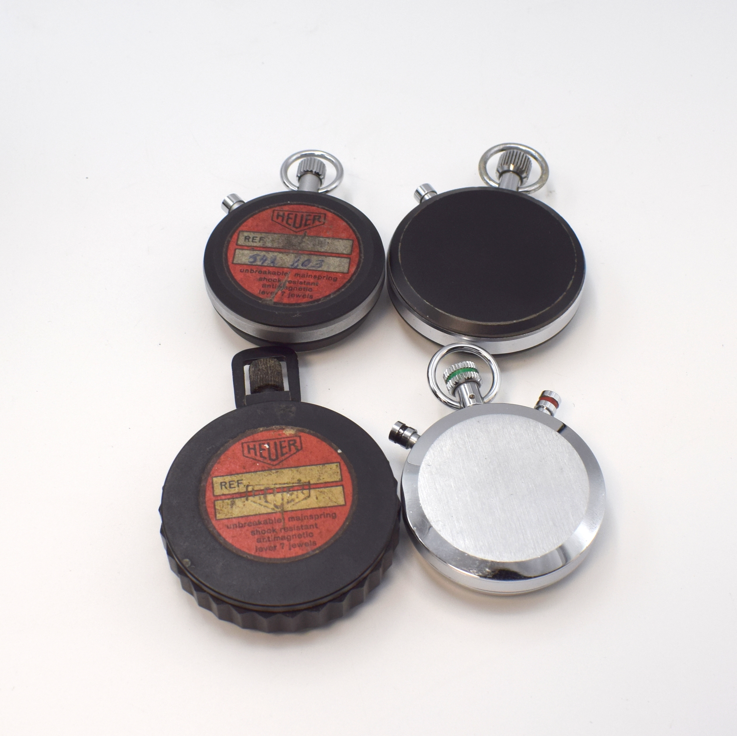 Detail a: HEUER Set von 5 Stoppuhren und 5 Ring-Master Lünetten, 4 Einhandstoppuhren: Typ Super Track im verchromten Geh., D. ca. 53 mm, Typ All-Sports matt ...