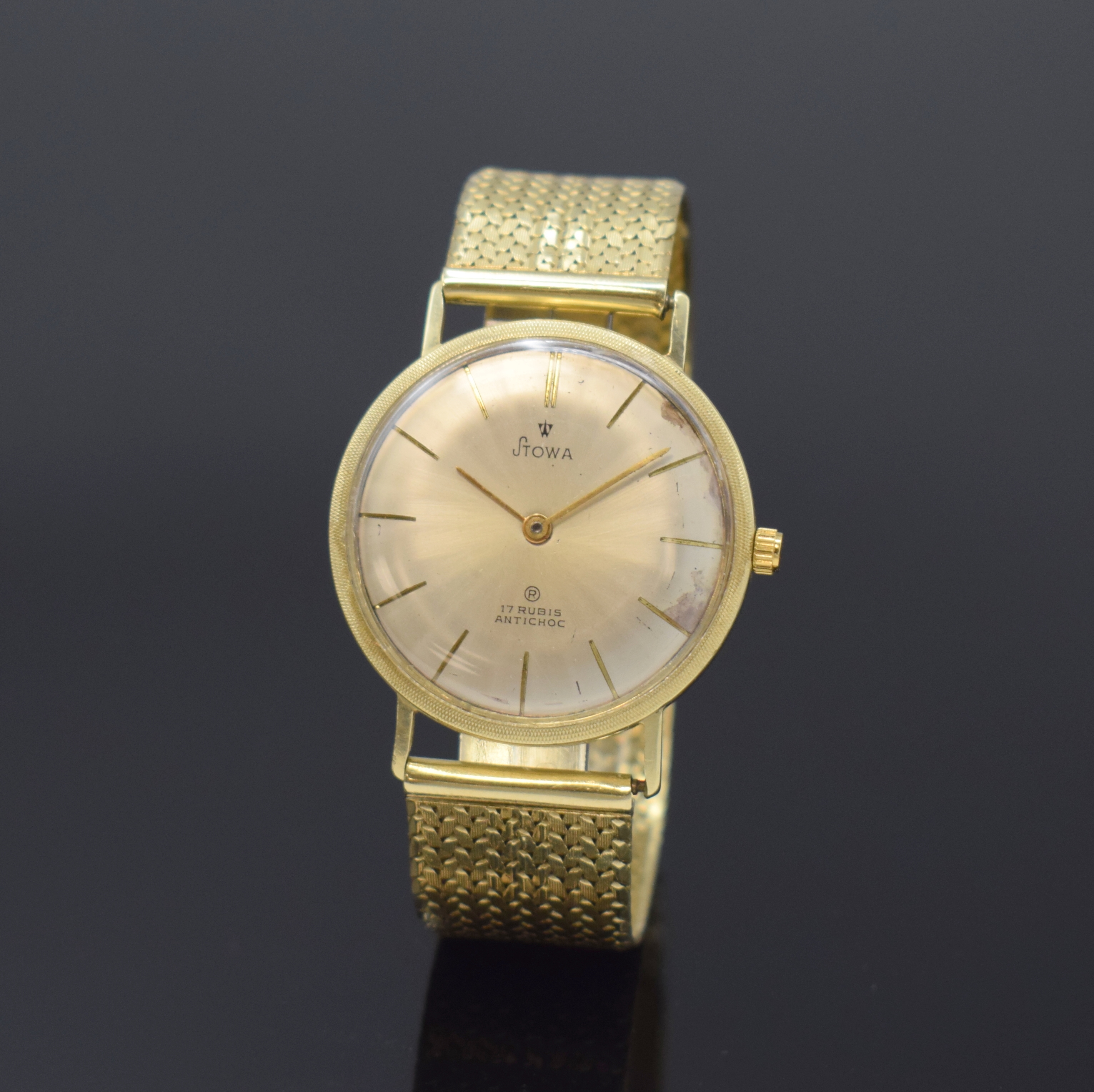 STOWA Herrenarmbanduhr in GG 585/000, Deutschland/Schweiz um 1965, Handaufzug, Boden aufgedr., silb. Zifferbl. fl./besch., gold. Std.-Ind. u. Zeiger, ...