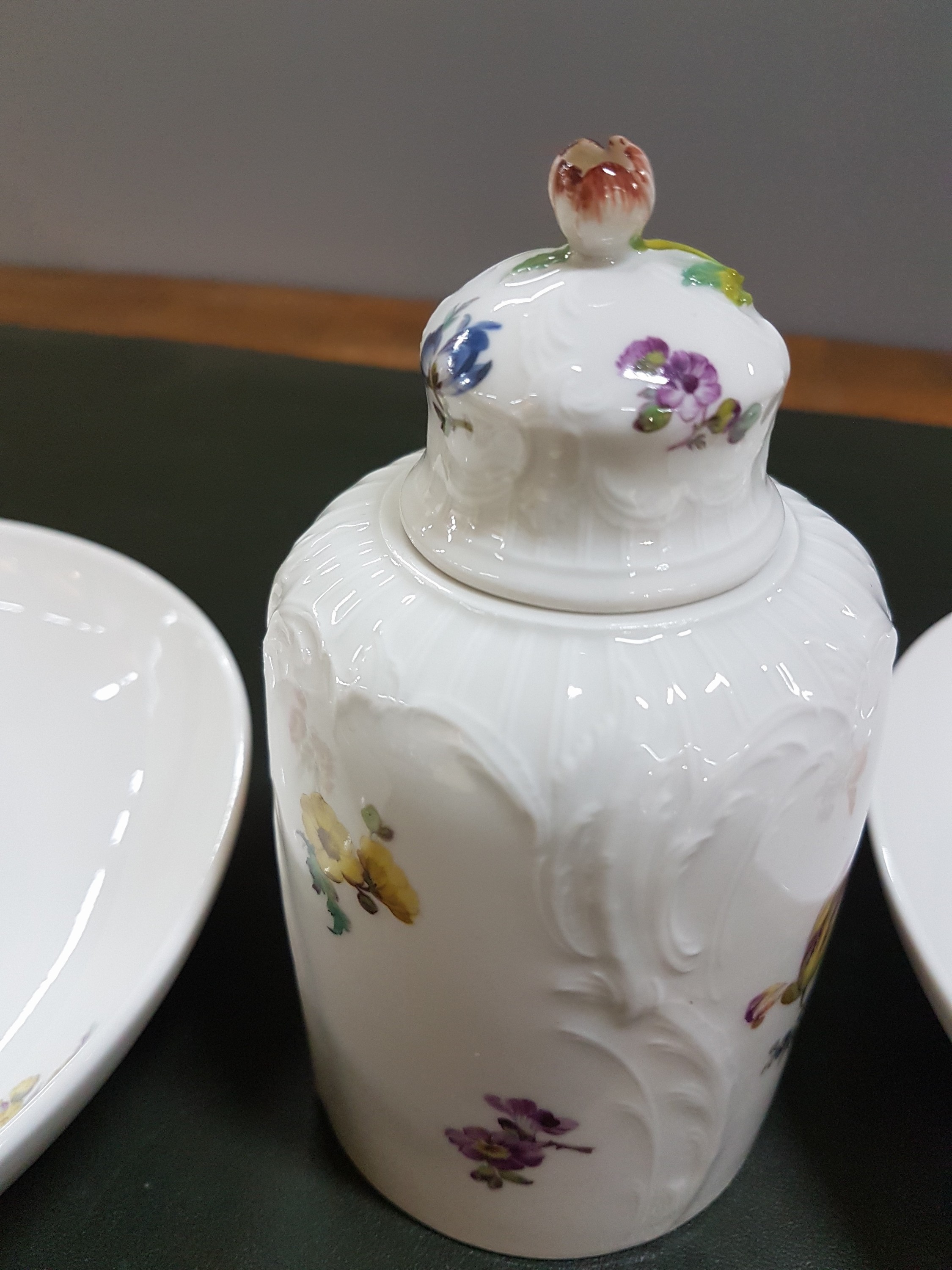 Detail c: Zwei Wandteller und eine Teedose, KPM Berlin, um 1909 - 1925, Teller mit feiner Blumenbukettmalerei, D. ca. 19 cm, Teedose Reliefzierrat, mit ...