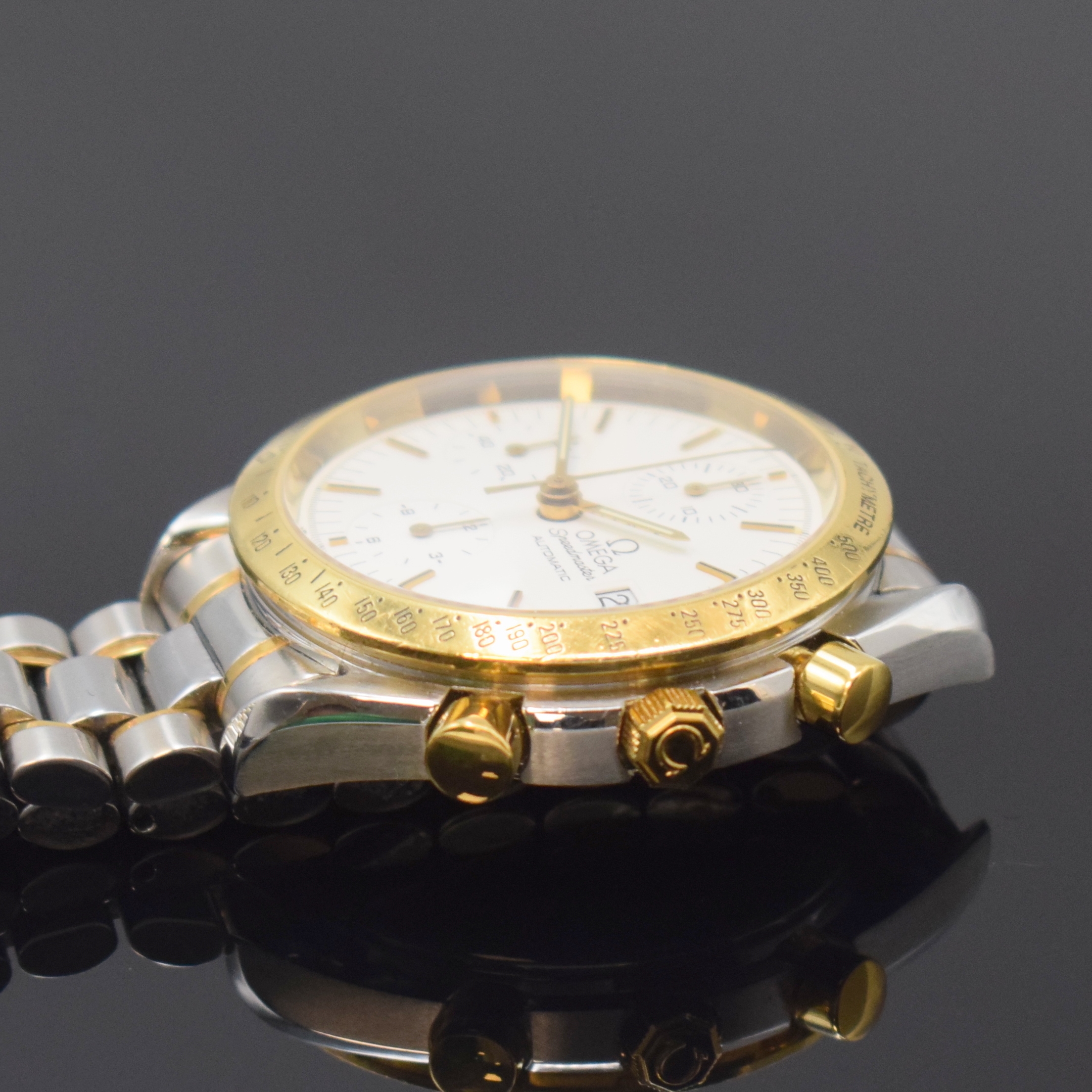 Detail c: OMEGA Speedmaster Herrenarmbanduhr mit Chronograph Referenz 175.0043/375.0043, Schweiz um 1995, Edelstahl/Gold komb., inkl. Gliederband m. Faltschl., ...