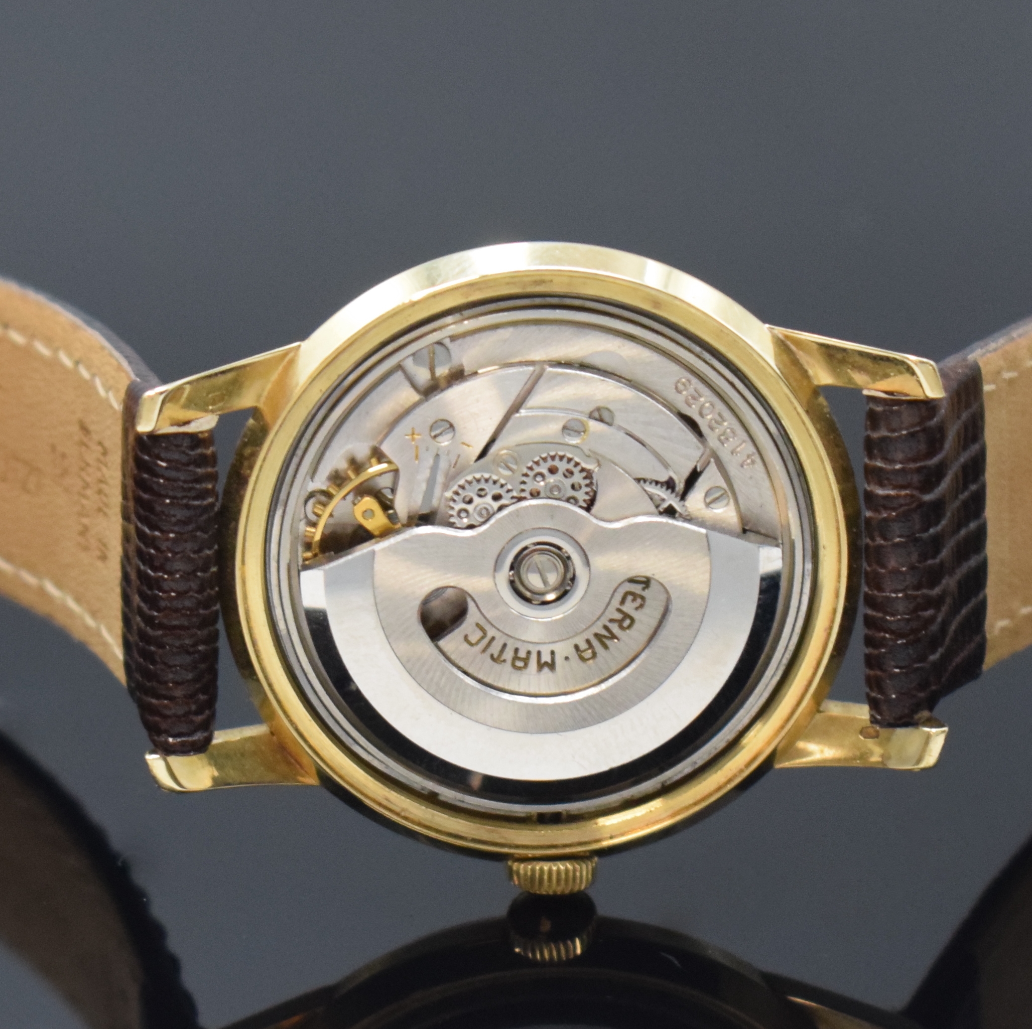 Detail e: ETERNA-MATIC Armbanduhr in GG 585/000, Schweiz um 1960, Boden verschr., Zifferbl. m. aufges. gold. Indizes altersbed. fl./pat., gold. Zeiger, rhod. ...