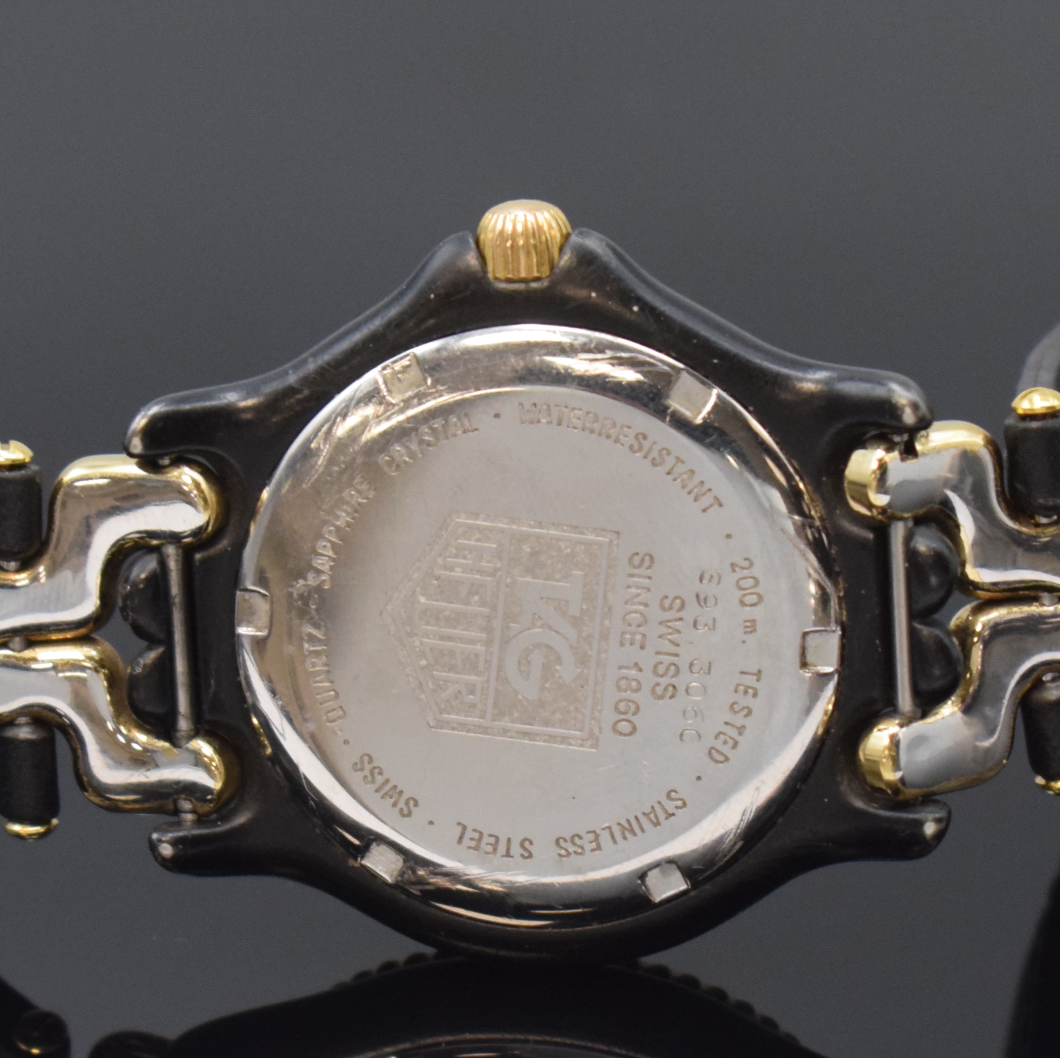 Detail c: TAG HEUER Armbanduhr Referenz S93.306, Schweiz um 1990, PVD-beschichtetes Edelstahlgeh. z. T. vergoldet, Boden und Krone verschr., Lün. m. 60er ...