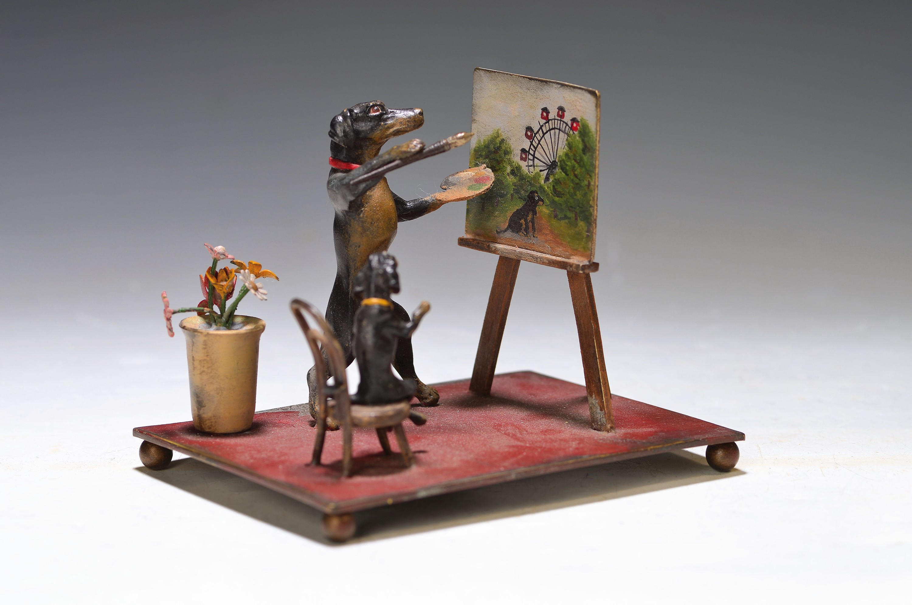 Große Wiener Bronze, Dackel als Maler malt den Prater, sign. Bergmann, daneben zuschauender Welpe auf Stühlchen und Blumentopf, ca. 9x11.5x9 cm, ...