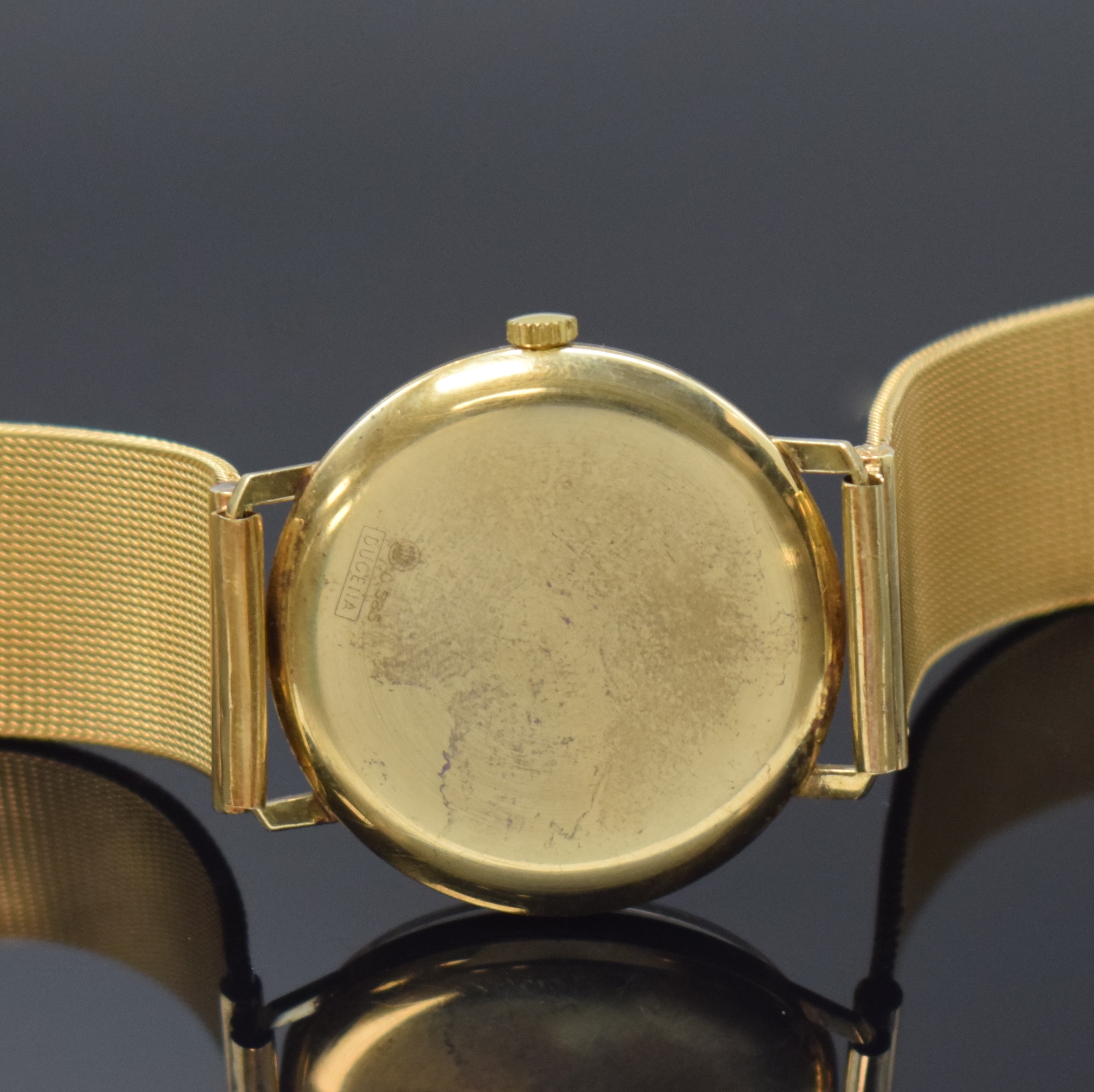 Detail d: DUGENA Festa Herrenarmbanduhr in GG 585/000, Schweiz um 1965, Handaufzug, Boden aufgedr., Goldband in GG 750/000, silb. Zifferbl. m. gold. Std.-Ind., ...