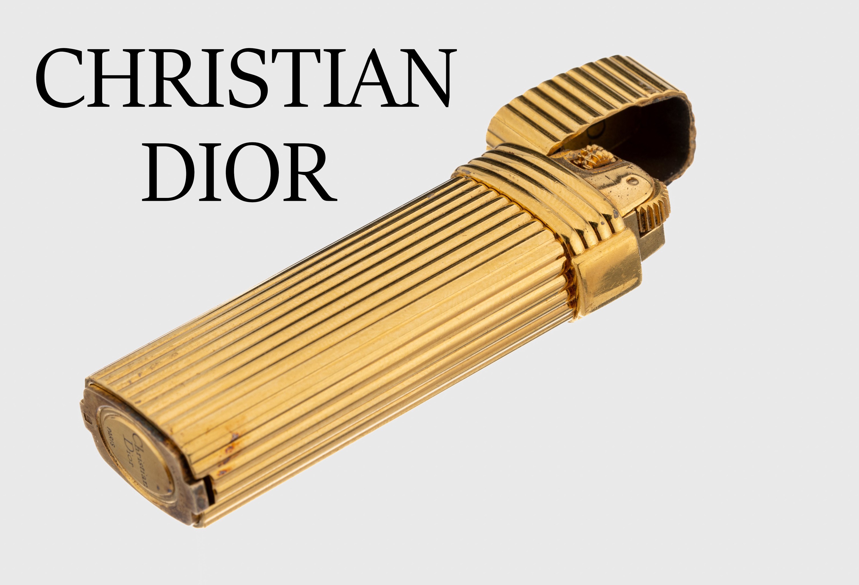 CHRISTIAN DIOR Feuerzeug, Metall vergoldet,Rillendekor, Funktion ungepr., sign.