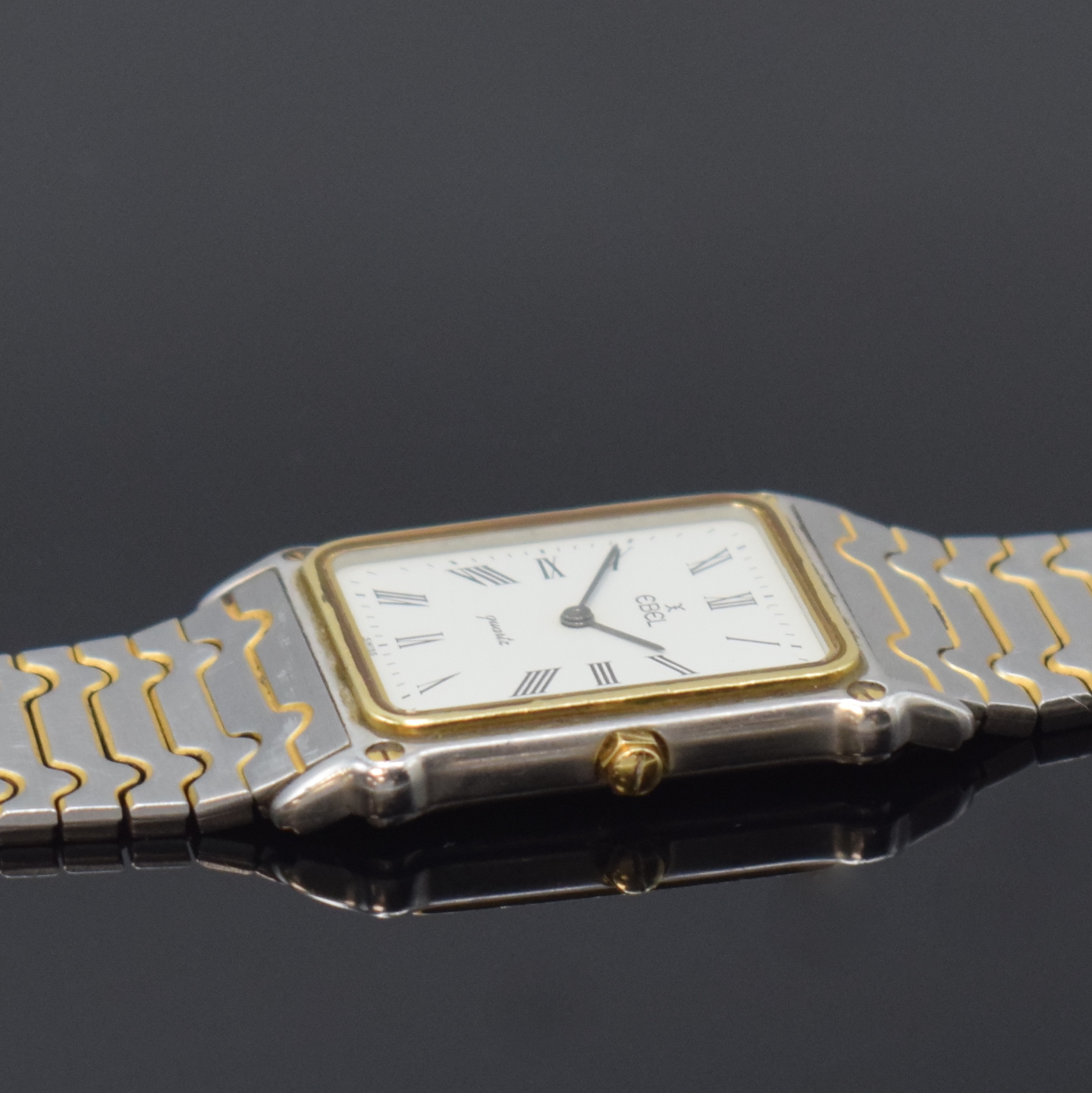 Detail c: EBEL Armbanduhr in Edelstahl, Schweiz um 1985, quarz, teils verg., Boden 4-fach verschr., orig. Gliederband, weißes Zifferbl. m. röm. Zahlen, ...