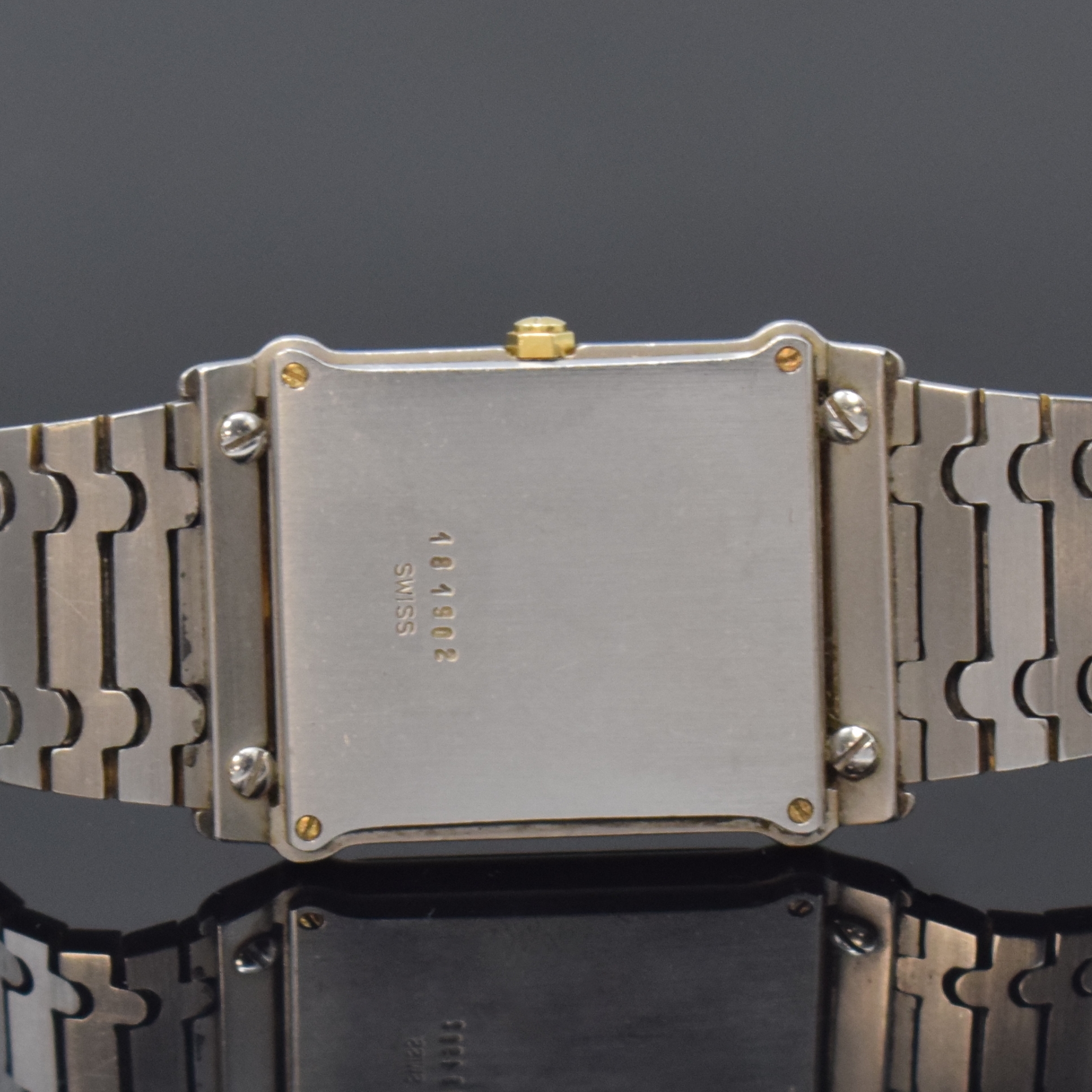 Detail d: EBEL Armbanduhr in Edelstahl, Schweiz um 1985, quarz, teils verg., Boden 4-fach verschr., orig. Gliederband, weißes Zifferbl. m. röm. Zahlen, ...