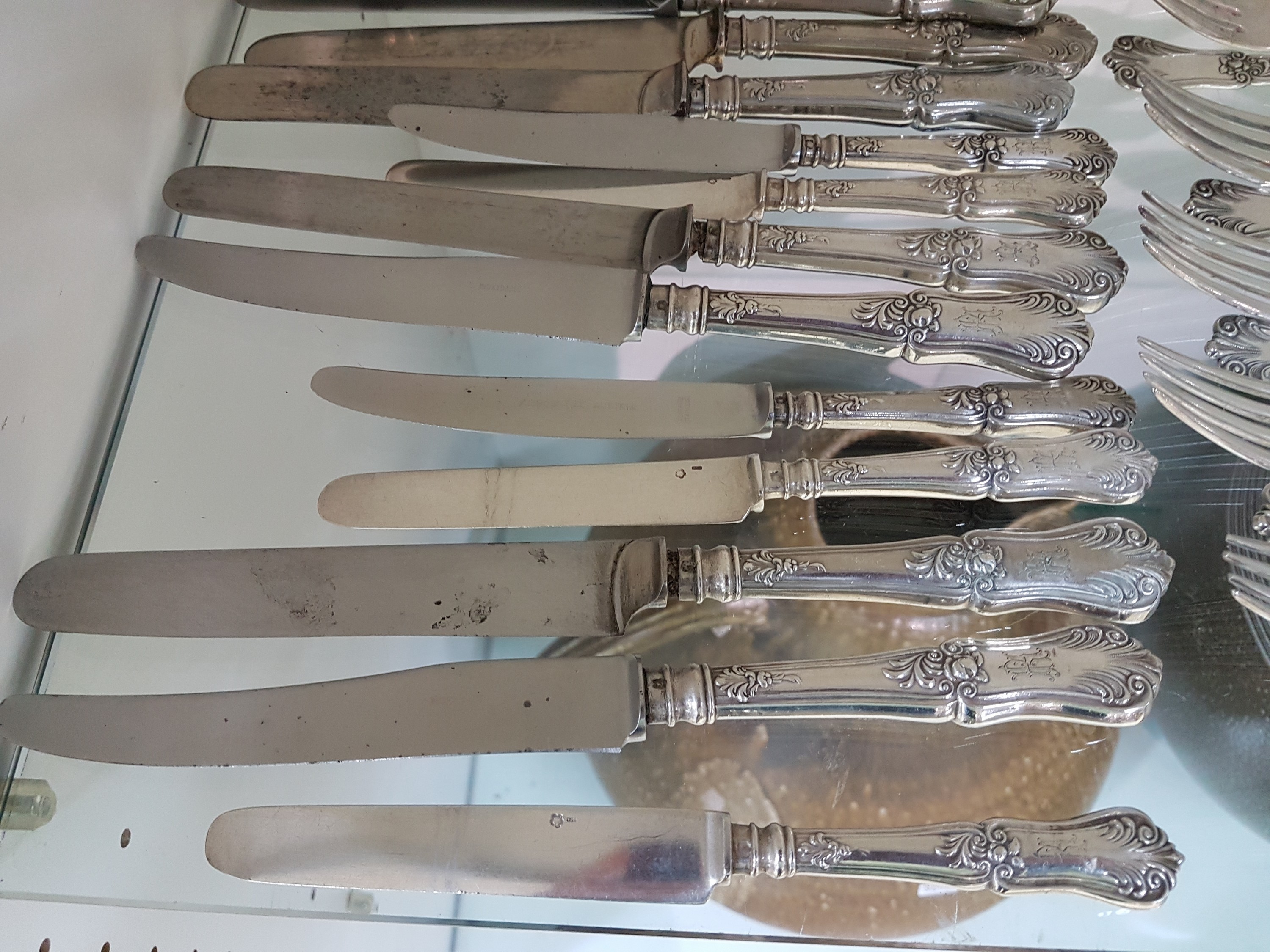Detail c: Silberbesteck, Österreich, um 1900, für 12 Personen, reich verziert, 12 Menuegabeln, 22 Menuemesser, 12 Suppenlöffel, 16 Dessertmesser mit ...