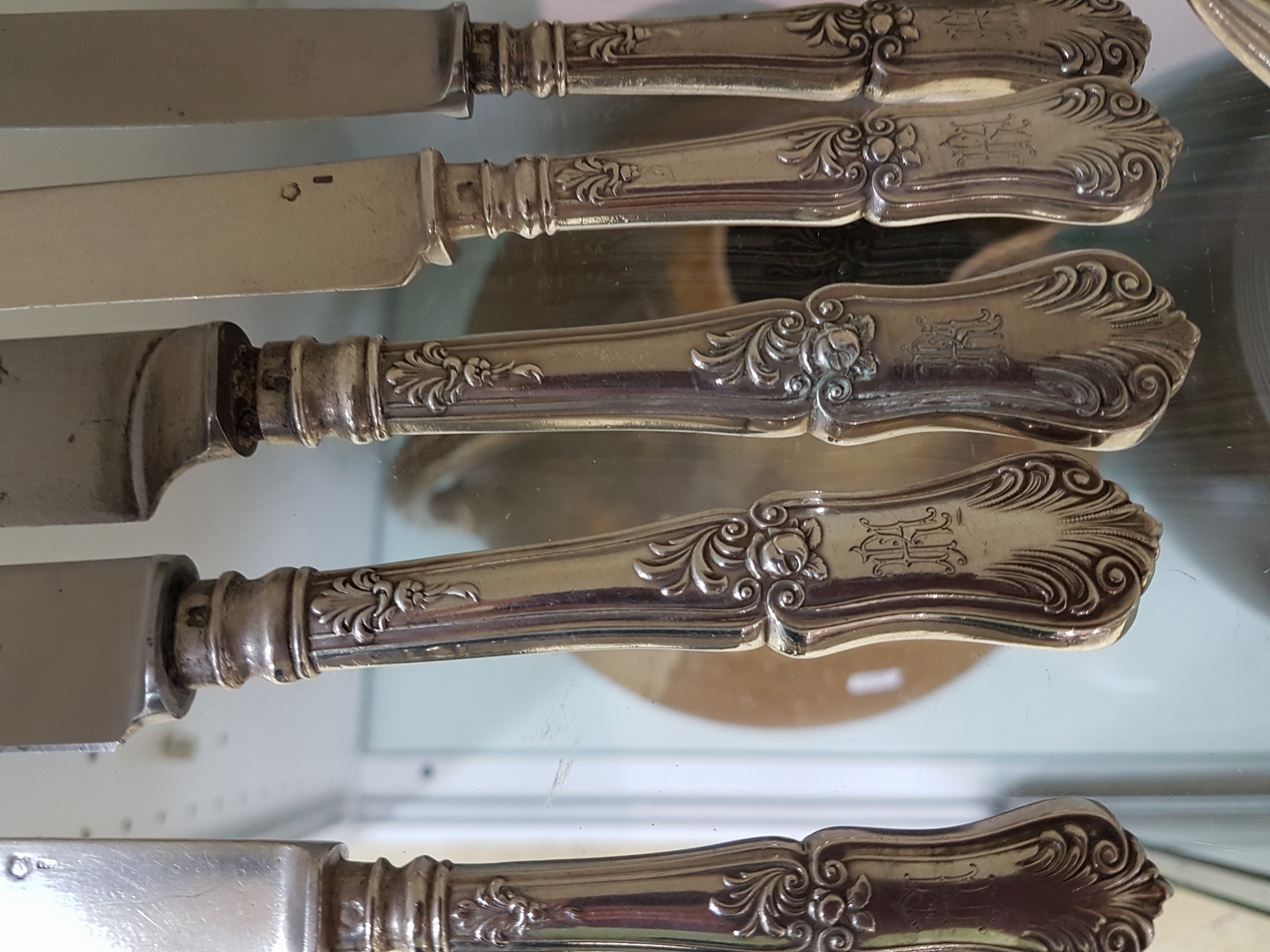 Detail d: Silberbesteck, Österreich, um 1900, für 12 Personen, reich verziert, 12 Menuegabeln, 22 Menuemesser, 12 Suppenlöffel, 16 Dessertmesser mit ...