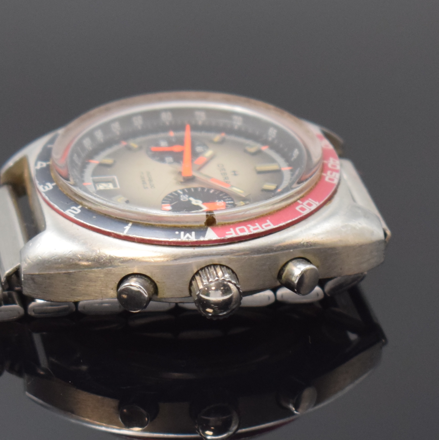 Detail b: OEBRA Herrenchronograph mit Tiefenmesser in Stahl, Schweiz um 1975, Handaufzug, neutr. Stahlband m. Faltschl., Boden u. Krone verschr., Lünette m. ...