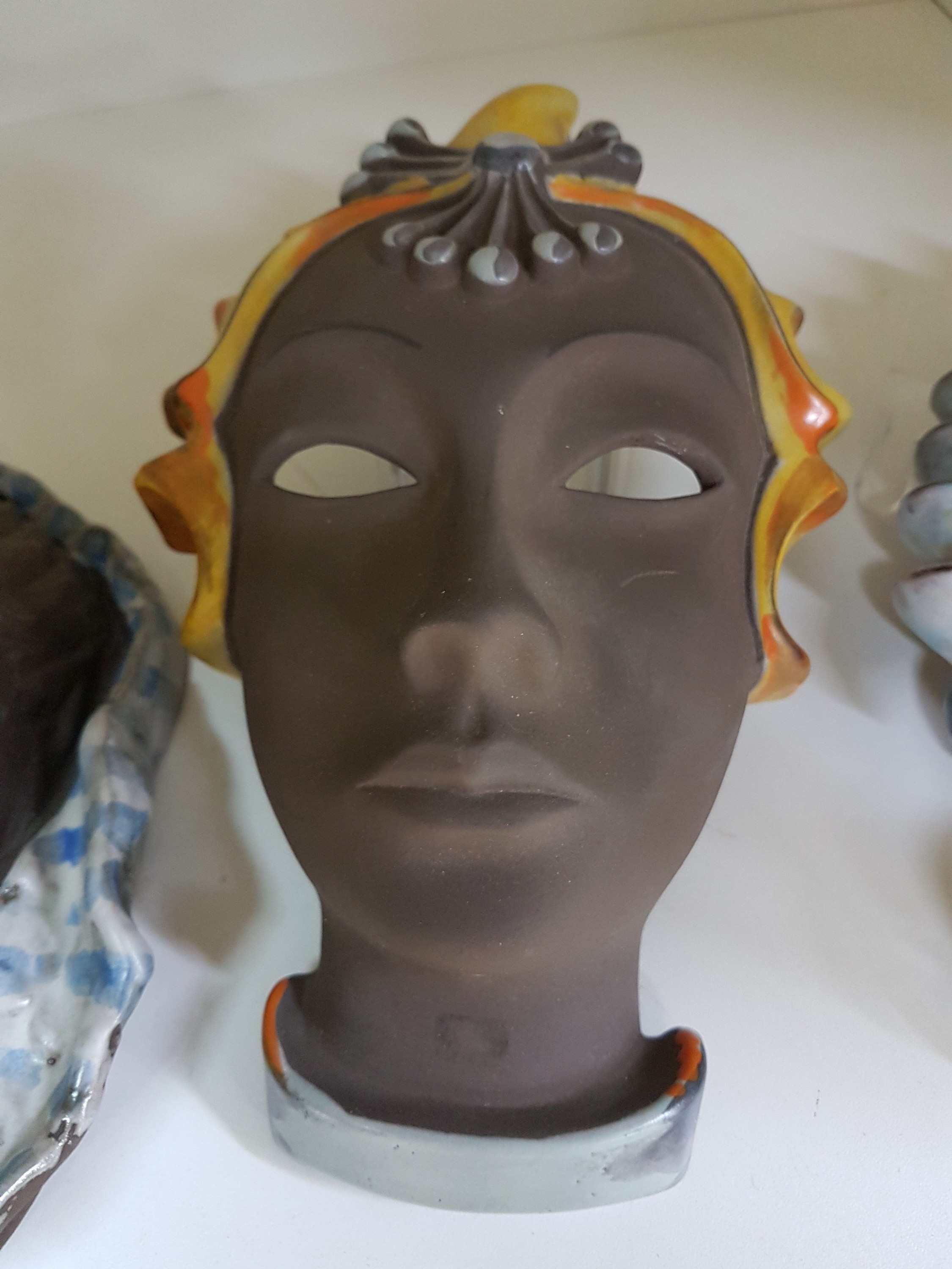 Detail b: 3 Wandmasken, Gertrud Woltershoff und Lore Friedrich-Gronau, Karlsruher Majolika, ungalsierter brauner Ton, Partien des Kopfschmuck farbig glasiert, ...